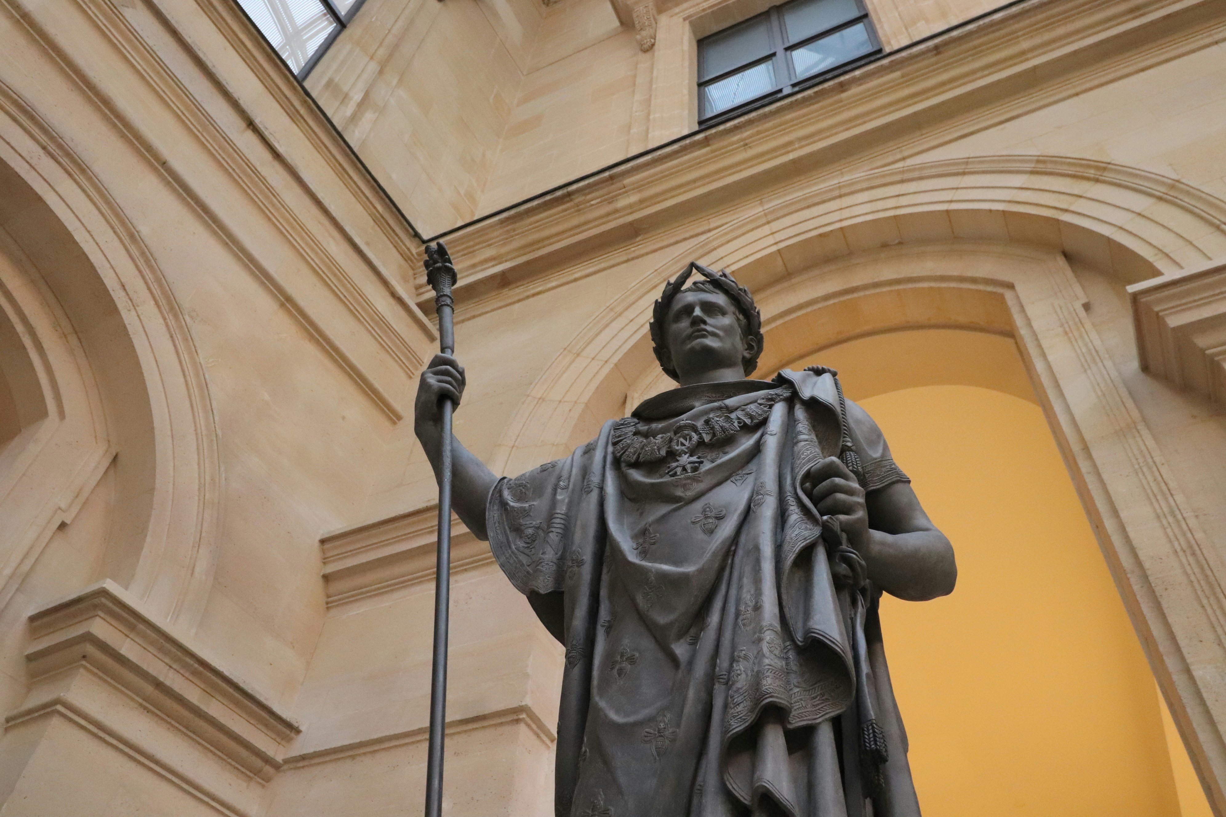 Statue of a man holding a scepter and orb.