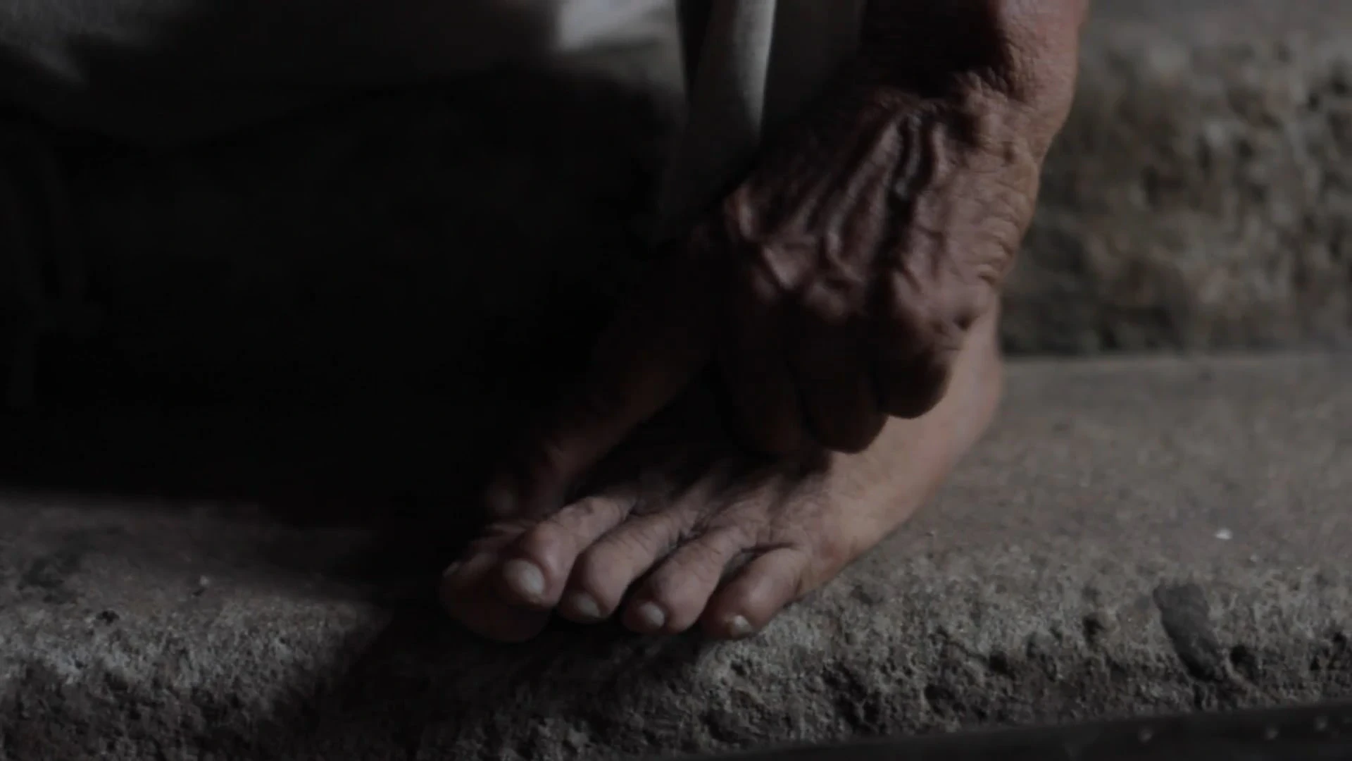 an old villager touches her toes 