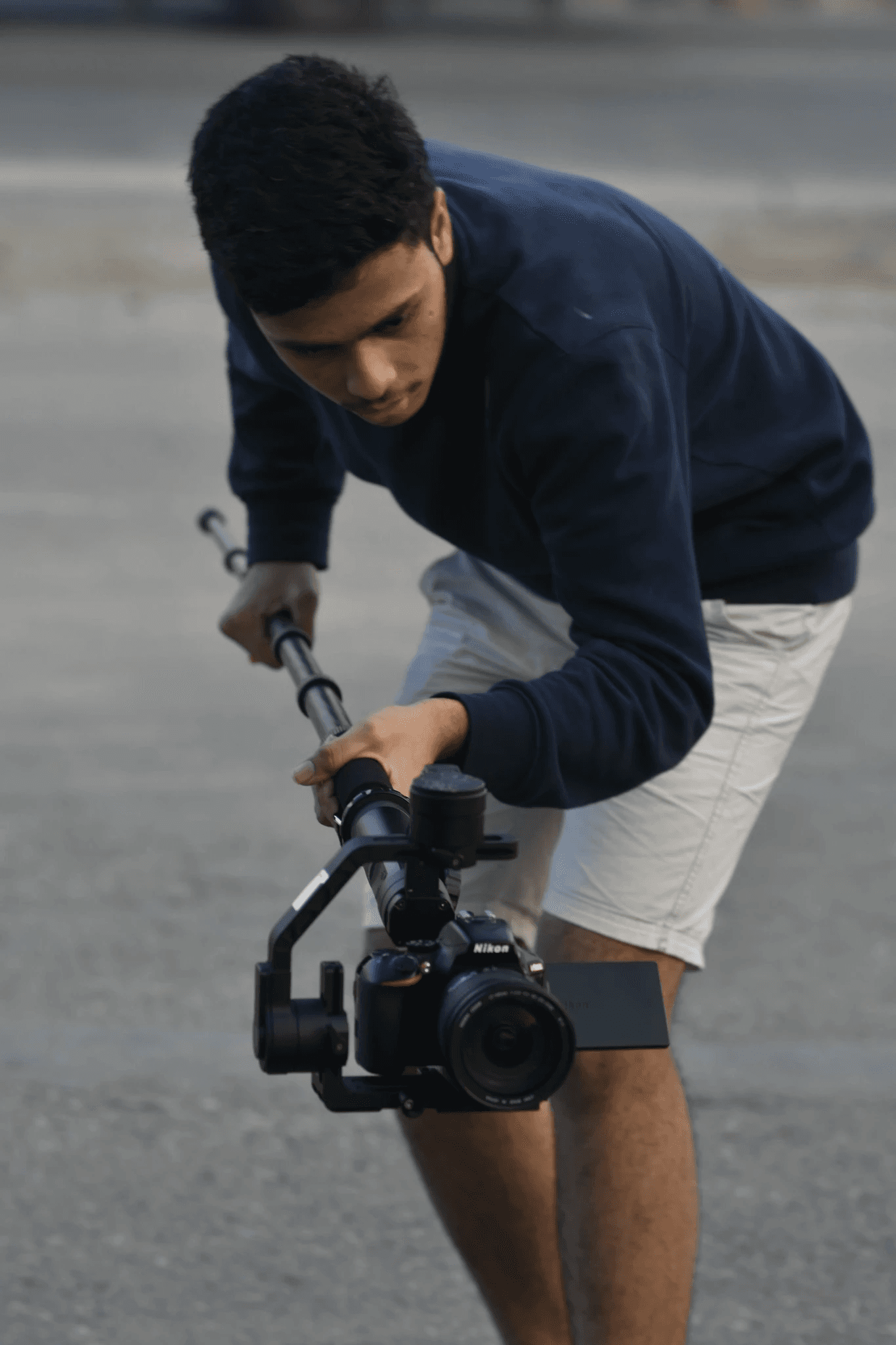 A man with a gimbal and a DSLR