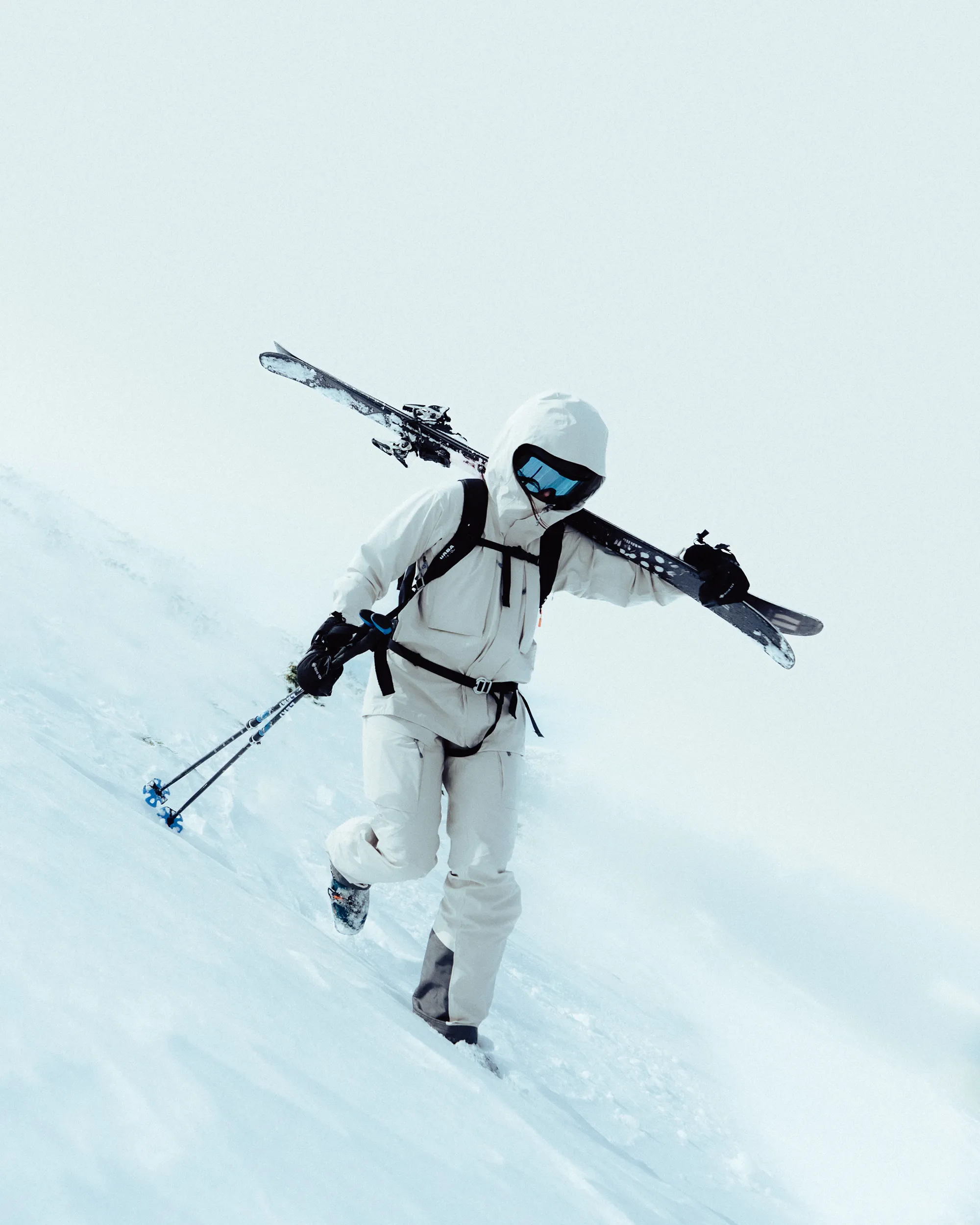 shot of a skier, carrying thier skis.