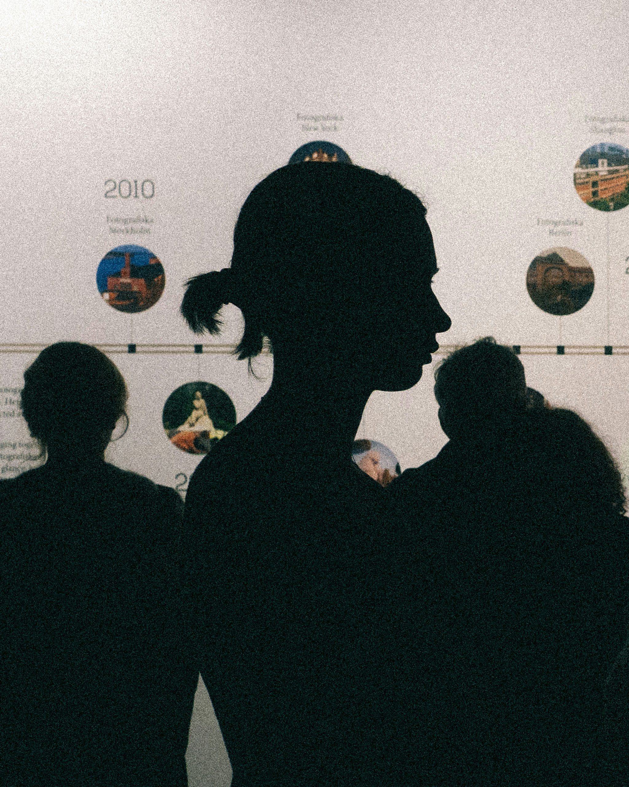 Silhouette of a woman and child against a timeline