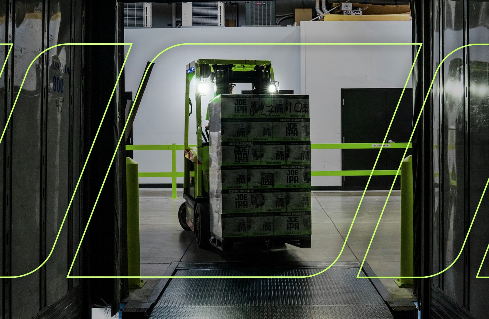 Forklift moving palletized freight inside a warehouse