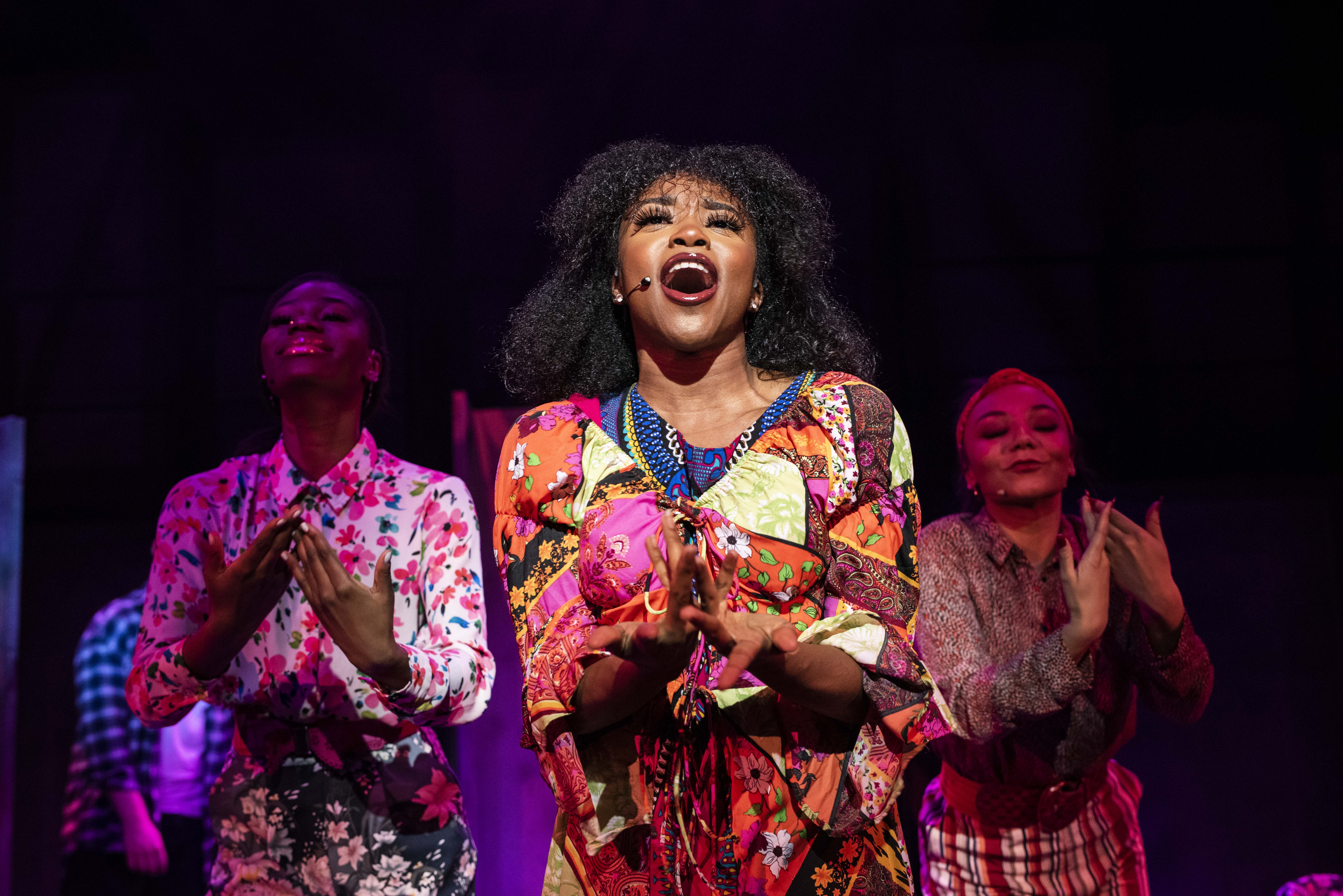 Student in centre stage singing at the Theatre play