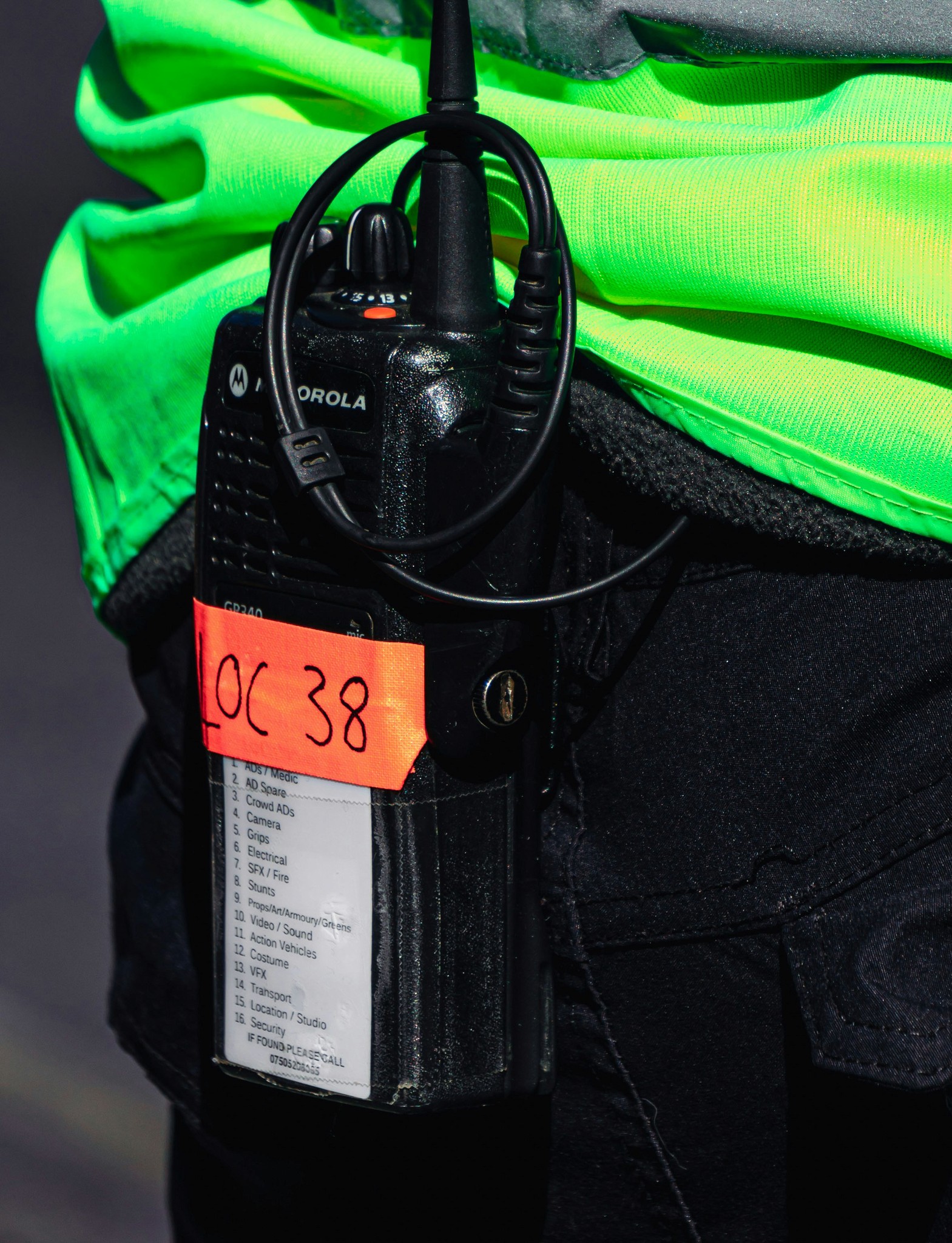 Close up of a radio walkie-talkie strapped to someones belt