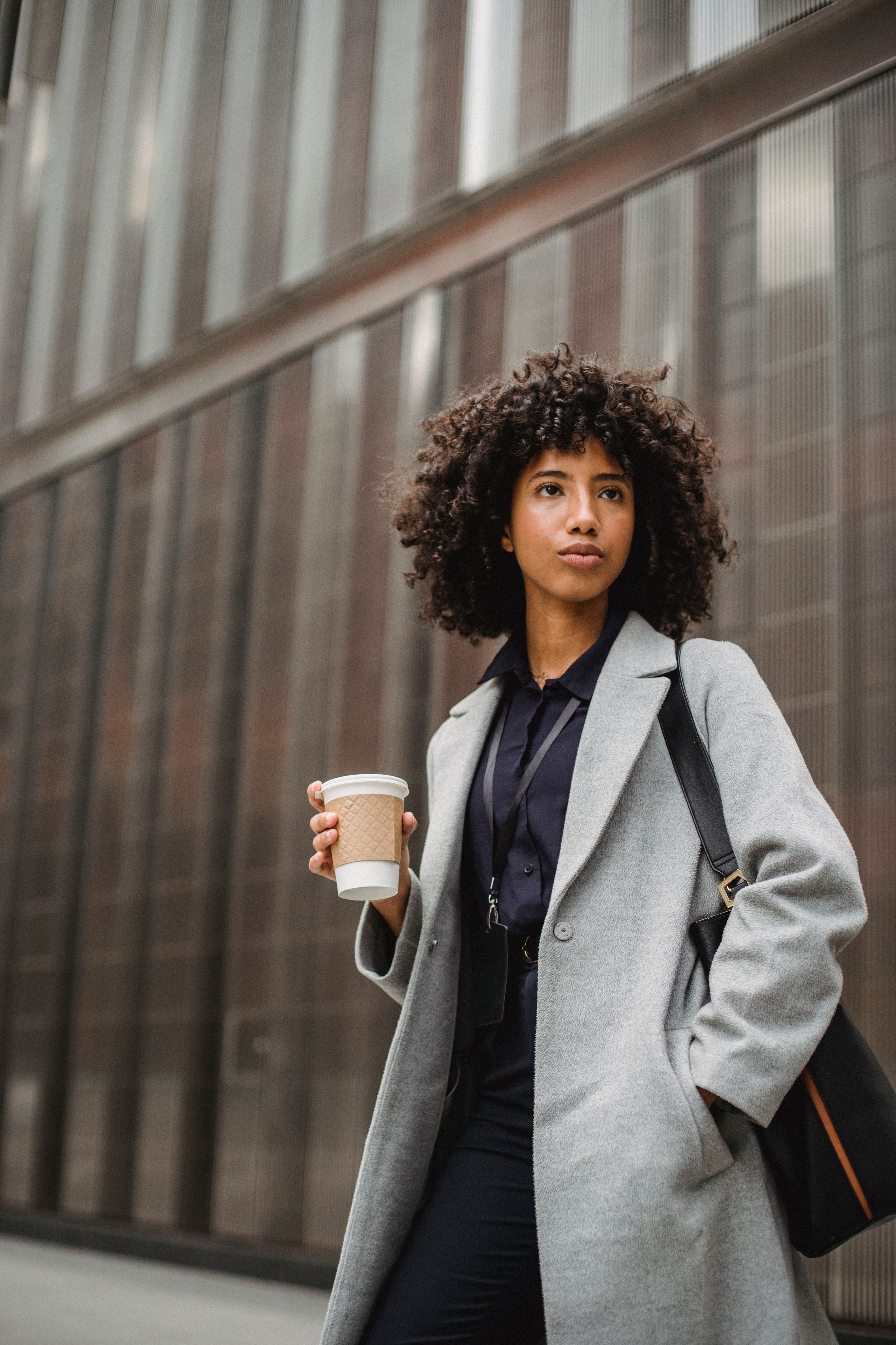 young-woman-in-grey-coat-holding-a-coffee-cup-while-walking-in-the-city. - roberto-hund (pexels)