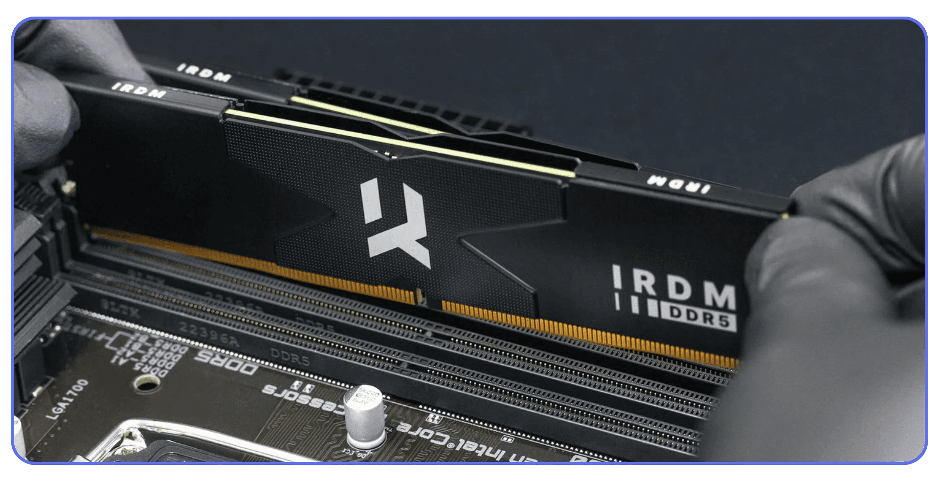 Technician installing IRDM DDR5 RAM module onto a motherboard
