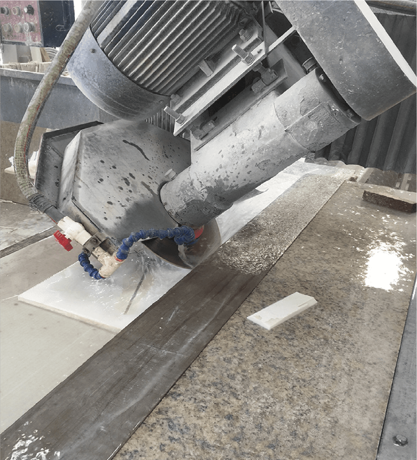 Close-up of the Manual Edge Cutting Machine cutting through a granite slab, demonstrating the machine's precision and capability to handle hard materials.