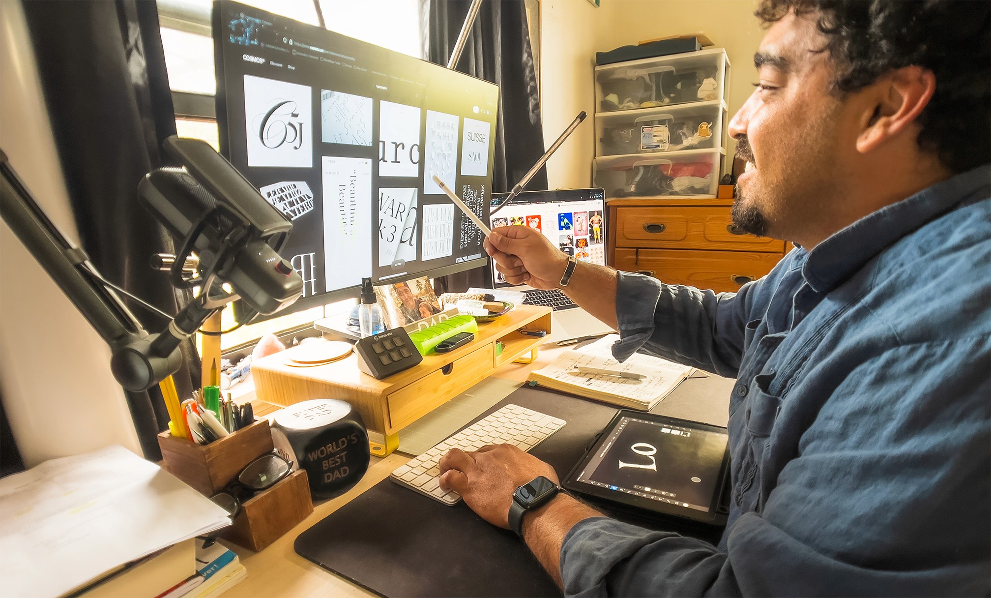 Designer using digital pen to refine logo concepts across multiple screens, showing the hands-on craft behind strategic brand identity systems that drive business recovery