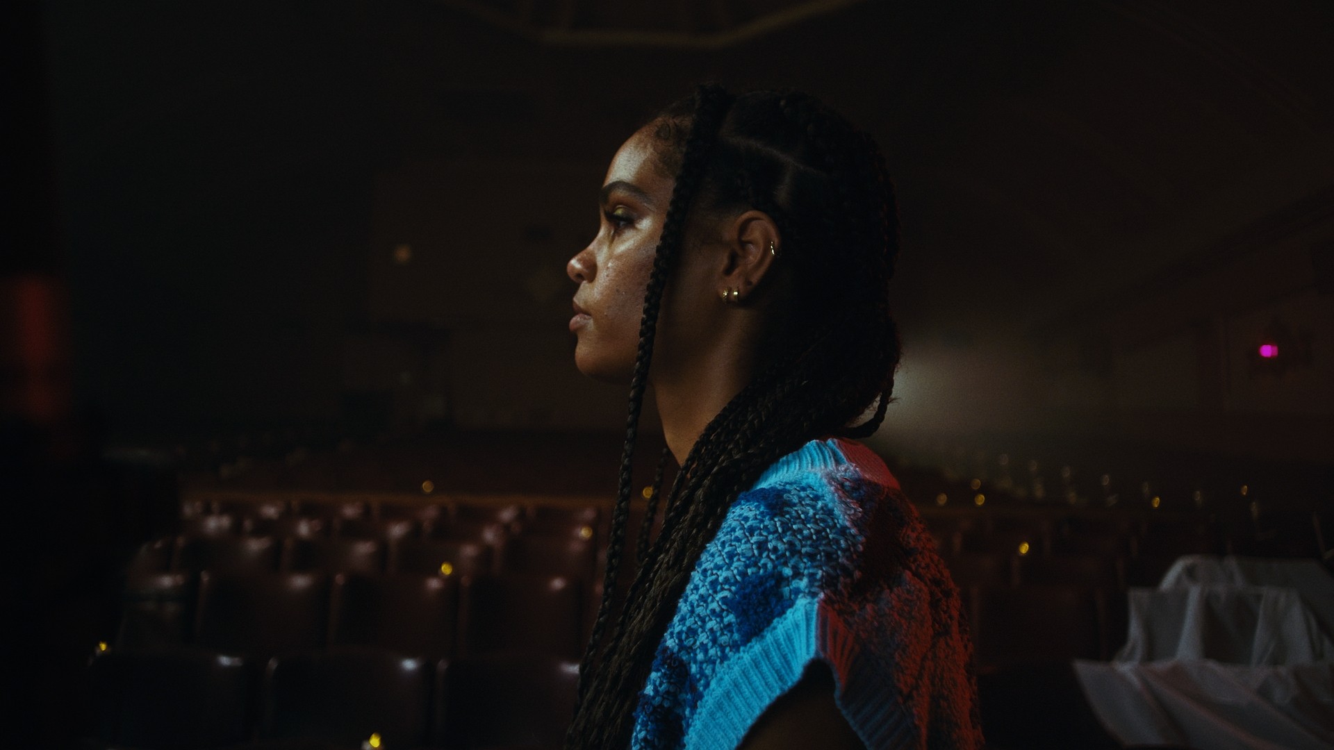 Person, holding a white rose behind his back with one arm on a light blue background