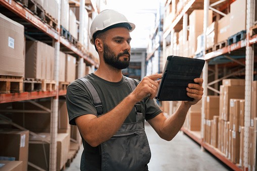 Worker performing inventory checks using TickedOff’s digital checklist tool