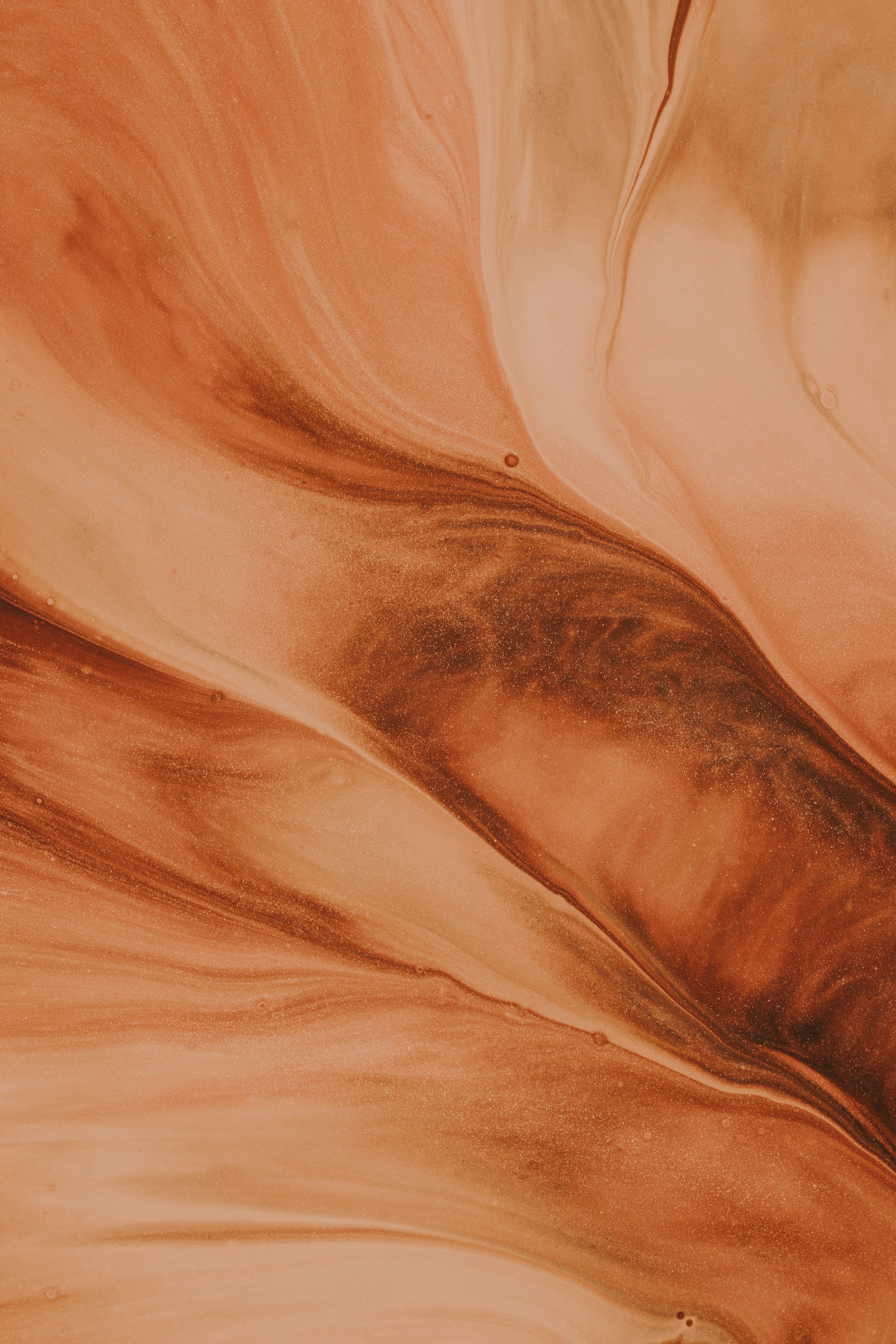 Abstract orange liquid background with a glittery texture