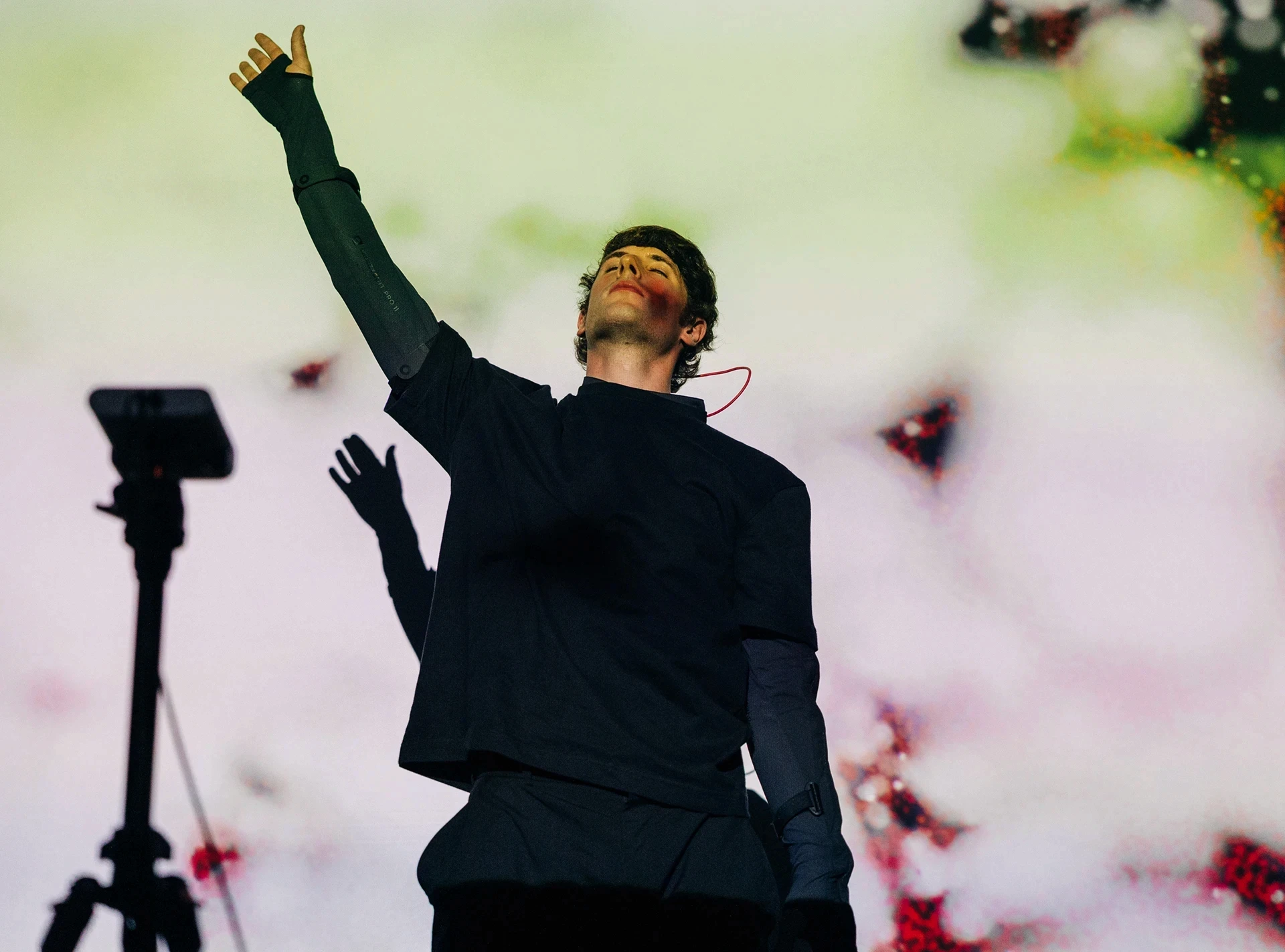 Man with arm raised on stage