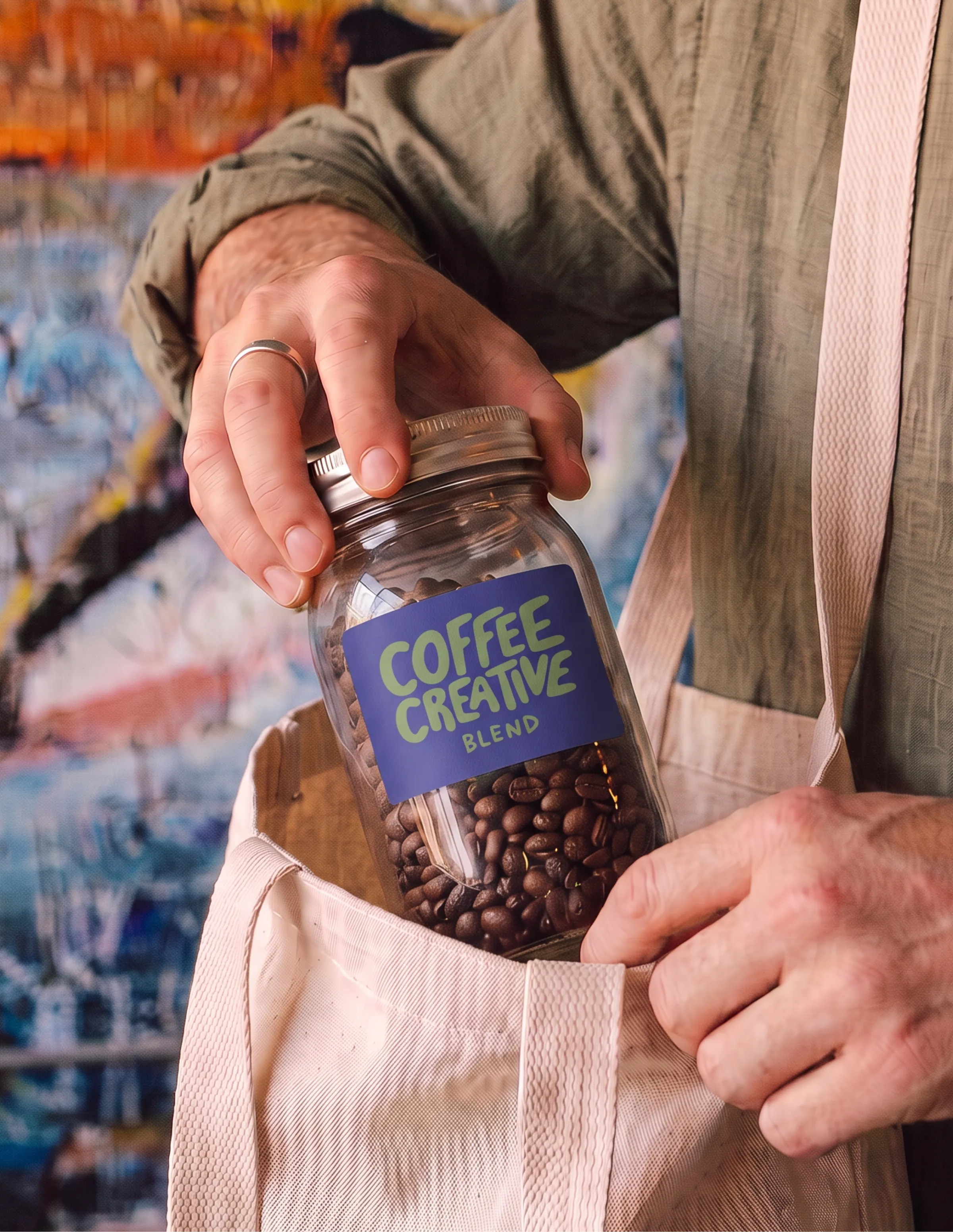 Coffee Creative logo label design on a glass coffee bean jar, held by a customer