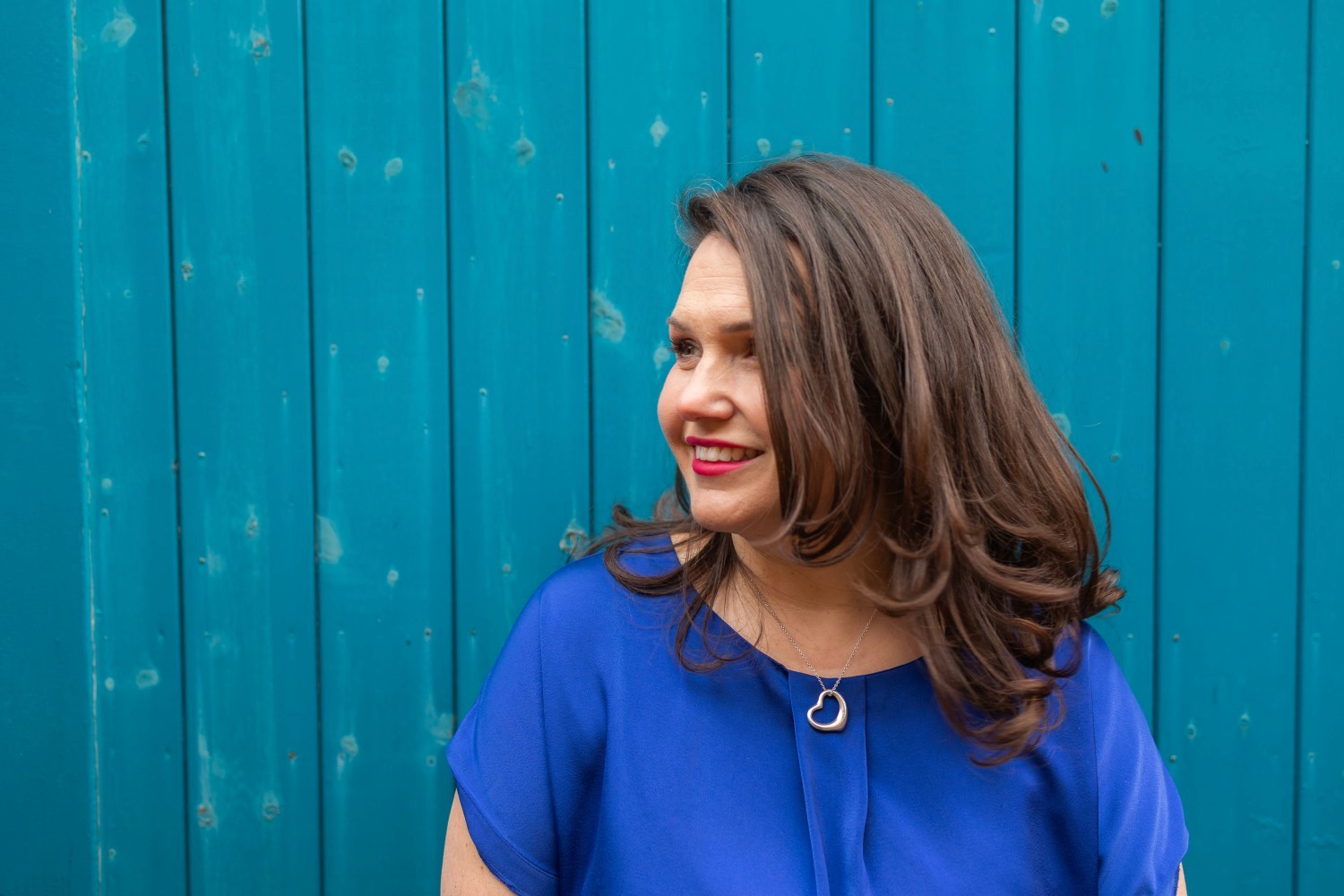 Woman jumping in vast white desert landscape