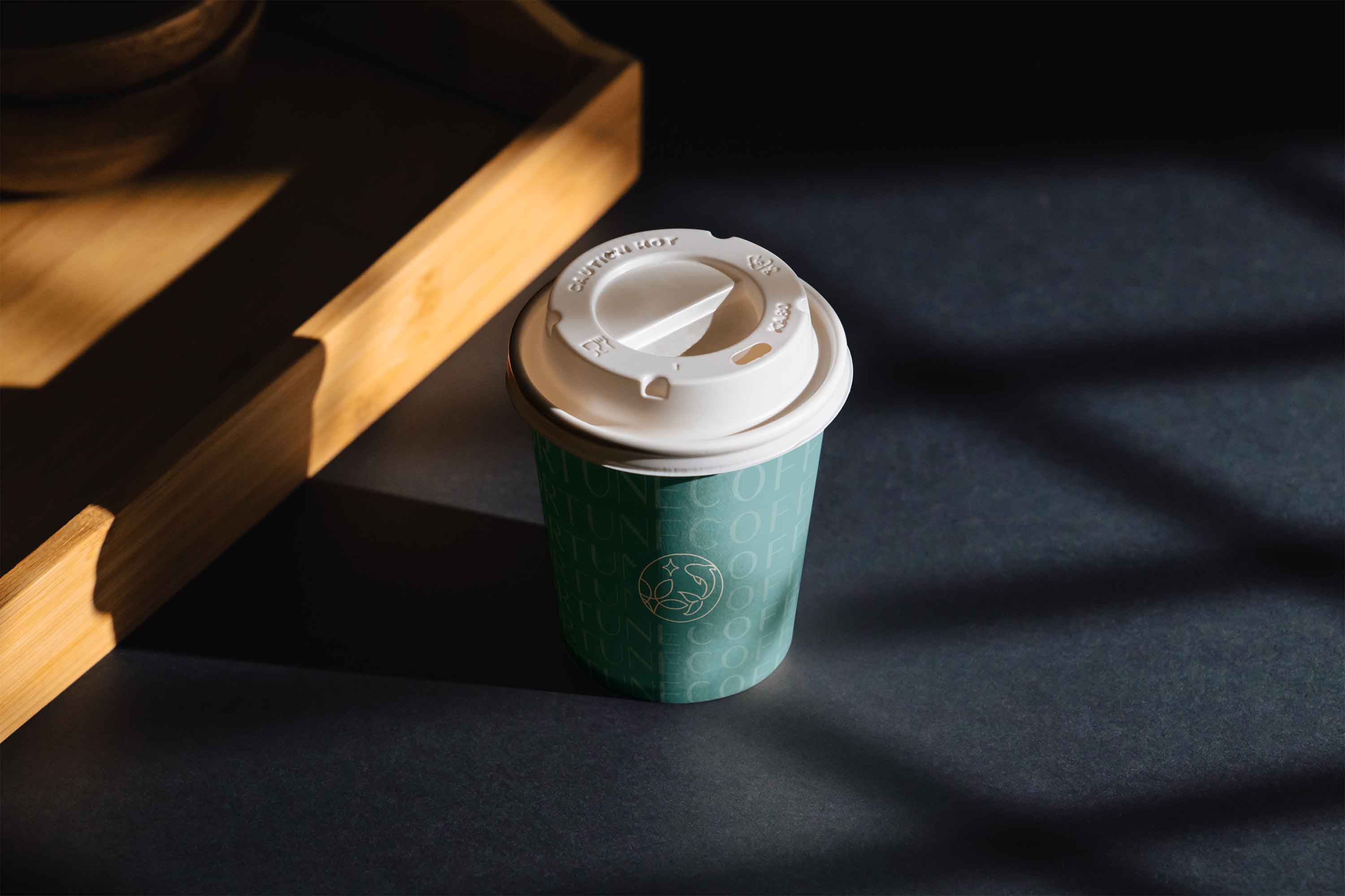 Close-up photo of a ceramic coffee cup with the "Fortune Coffee" logo.