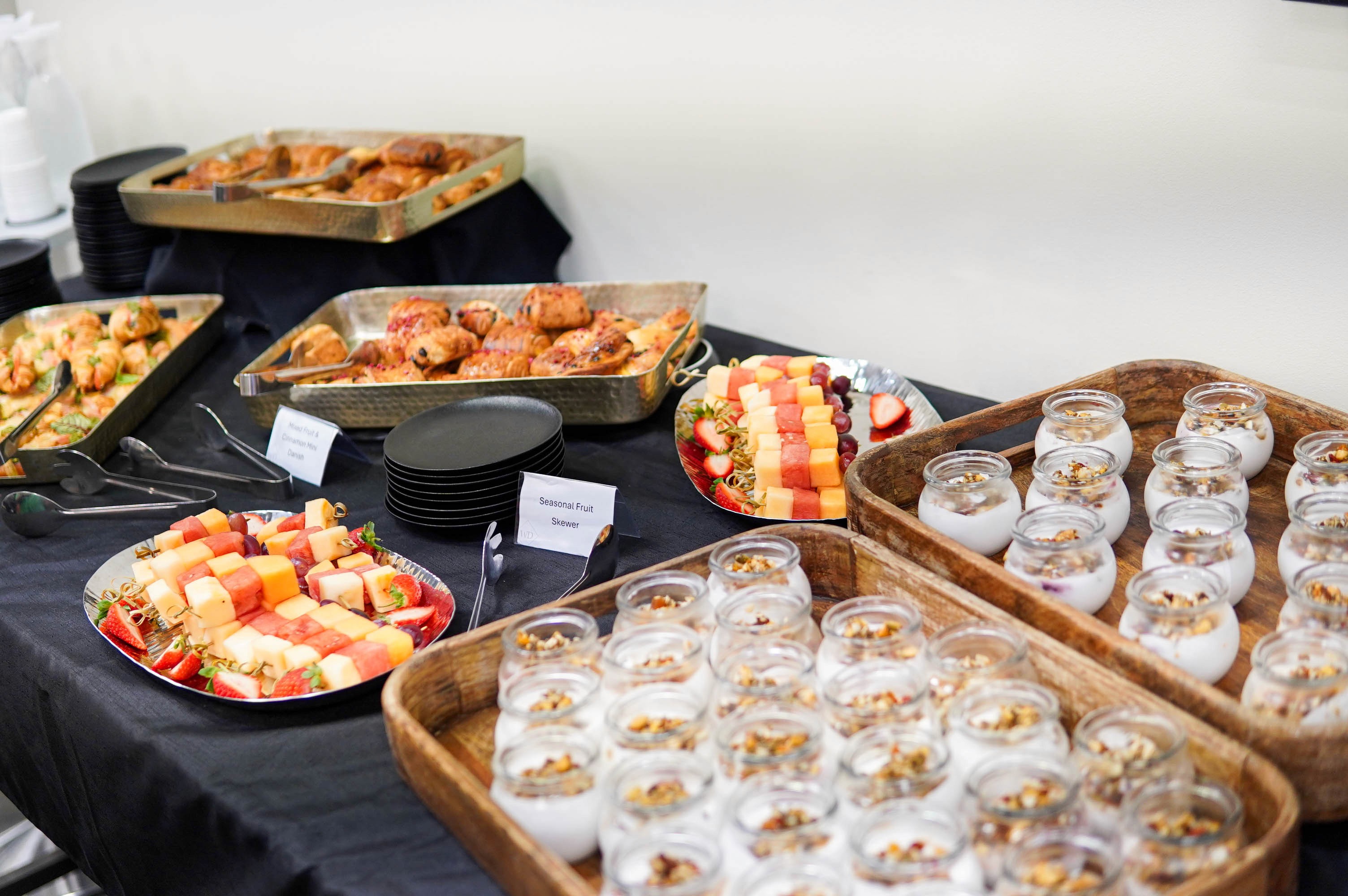 Morning tea station with yoghurt pots, danishes and fresh fruit