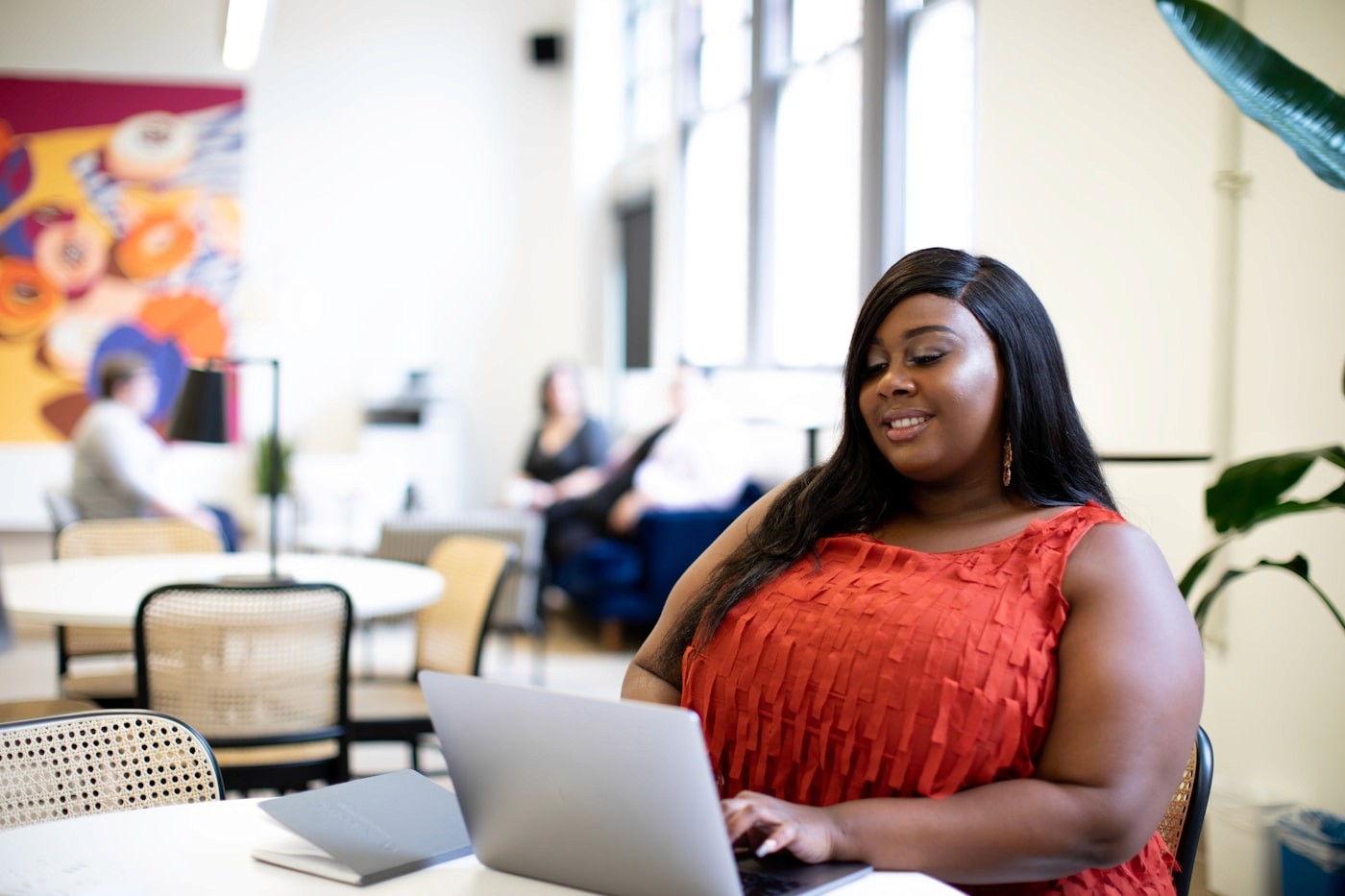 Black woman creating content on a laptop