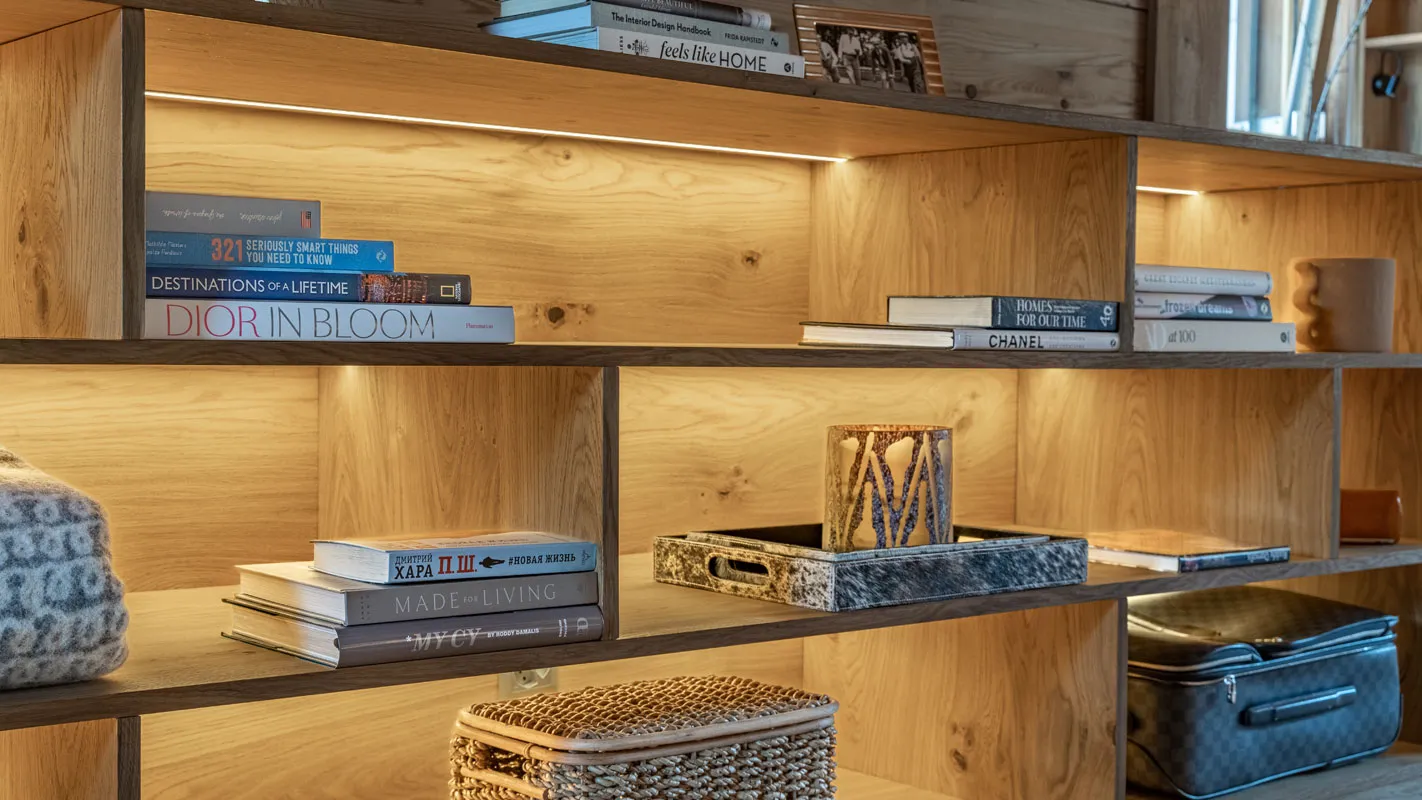 Silvretta Klosters built-in timber shelving with integrated lighting and curated books and accessories