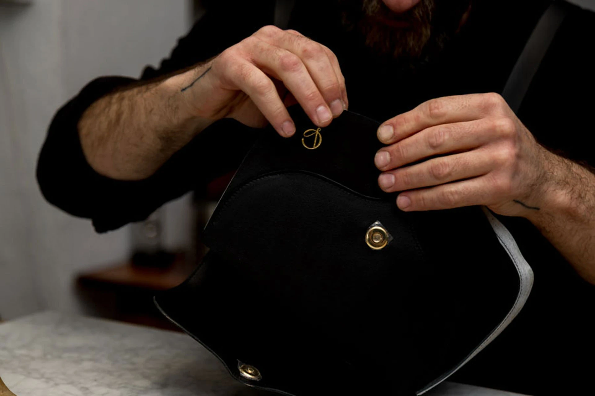 The open handbag reveals its volume, flap construction and fastening.
