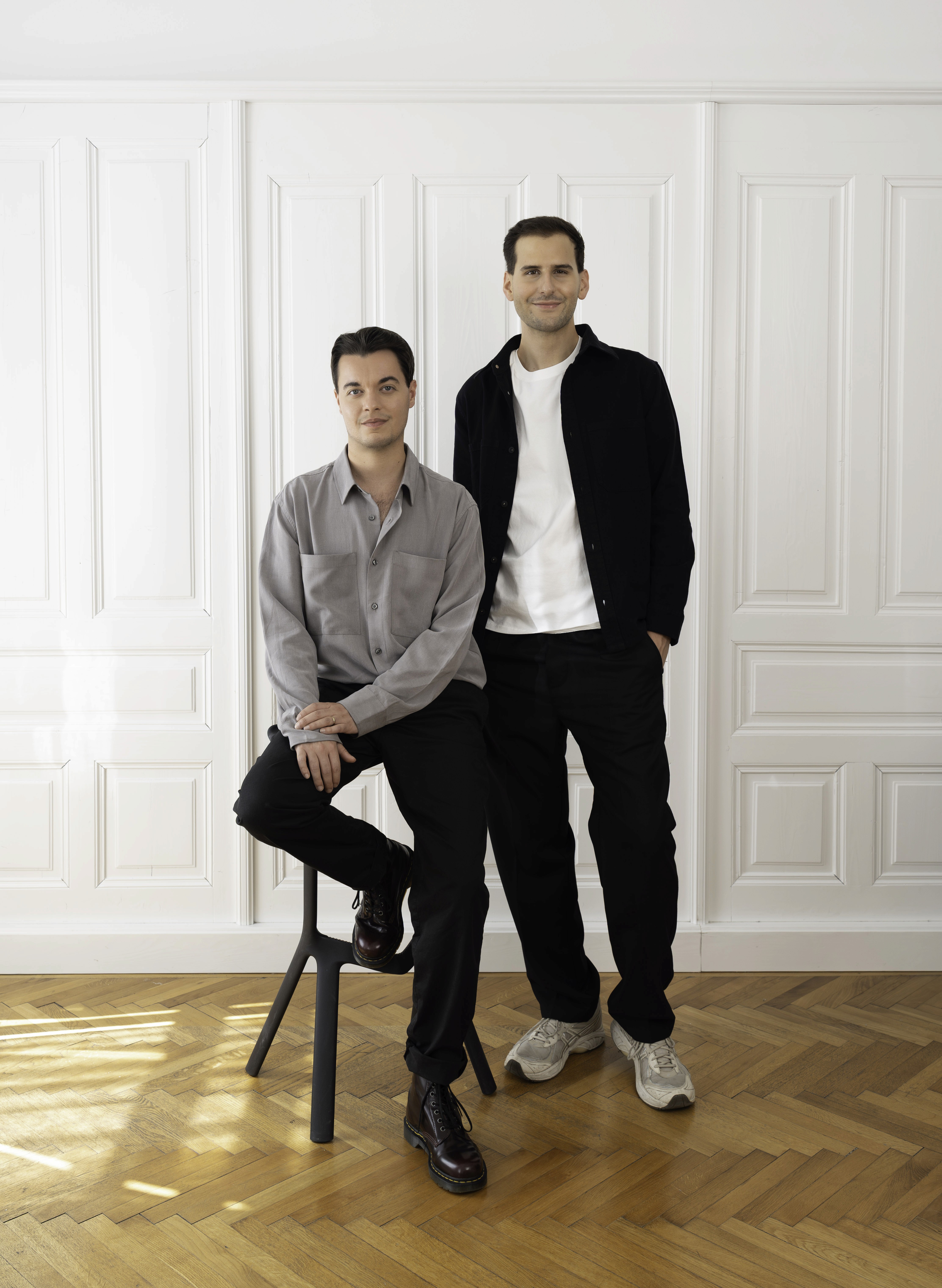 The image features a stylized figure with a unique, abstract design. The main subject appears to be a humanoid form with a wooden texture, wearing a blue robe.