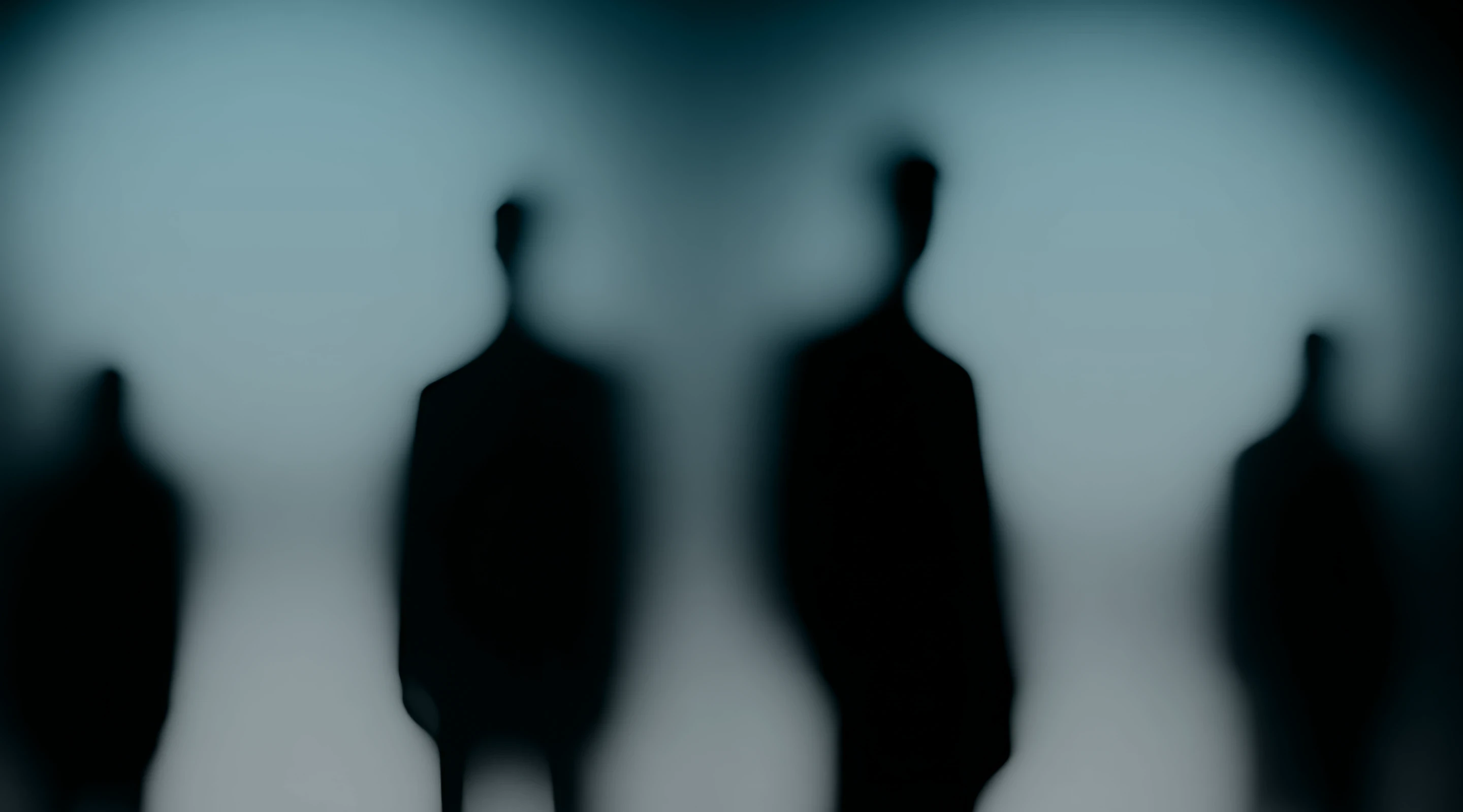 Blurred figures of people walking in a busy station.