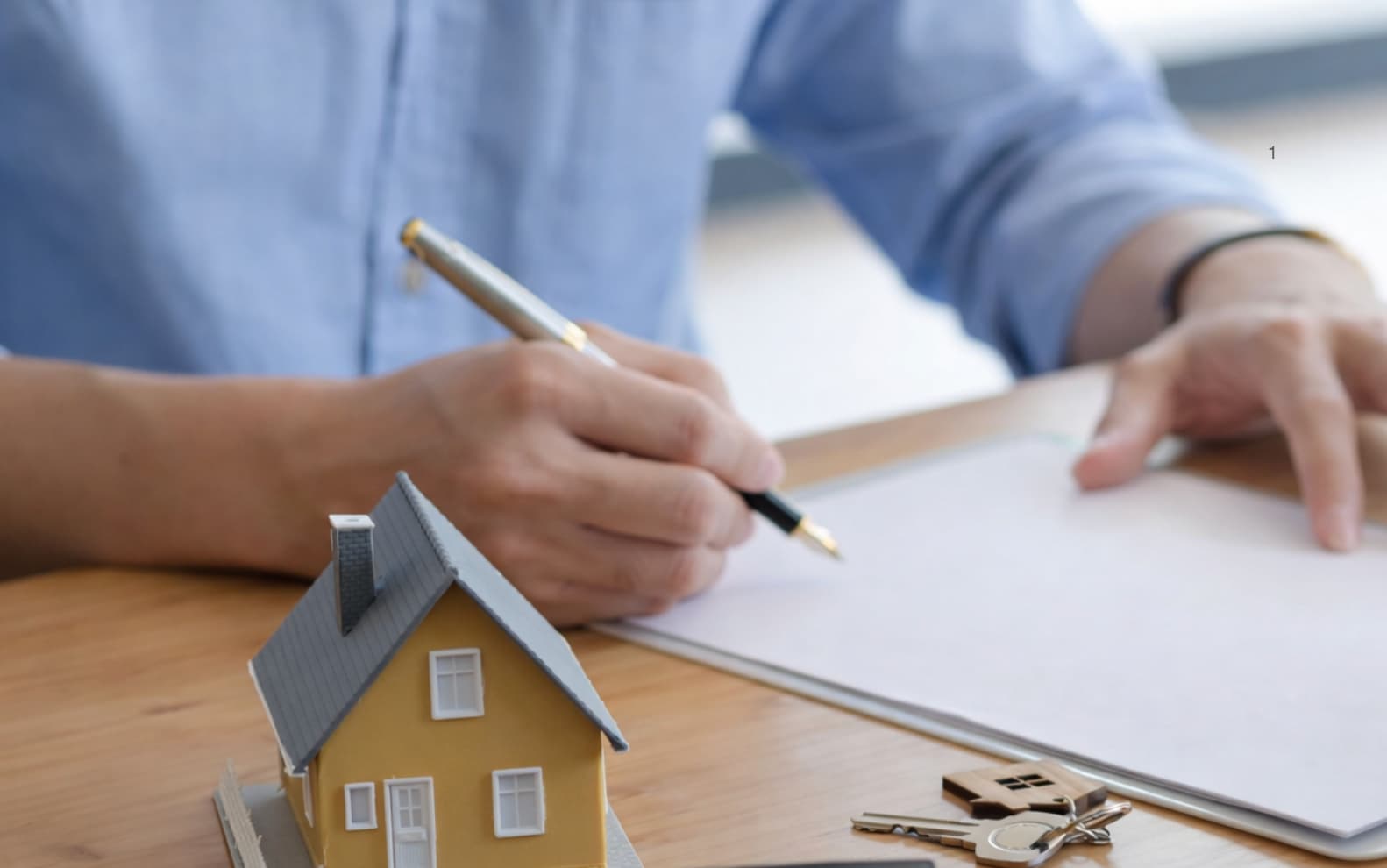 Podpisywanie umowy najmu przy modelu domu i kluczach