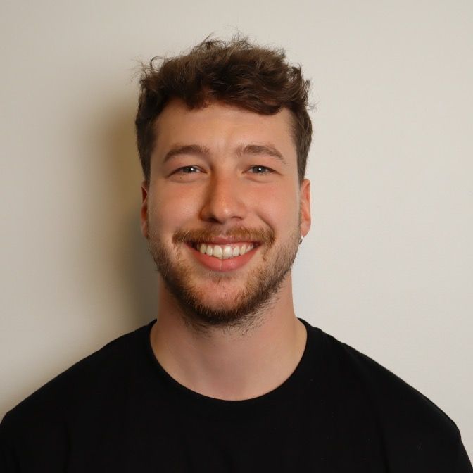 man standing near white wall
