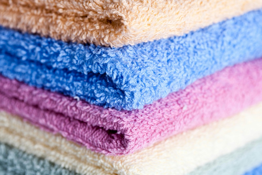 Stack of multicolored bath towels representing home and living products