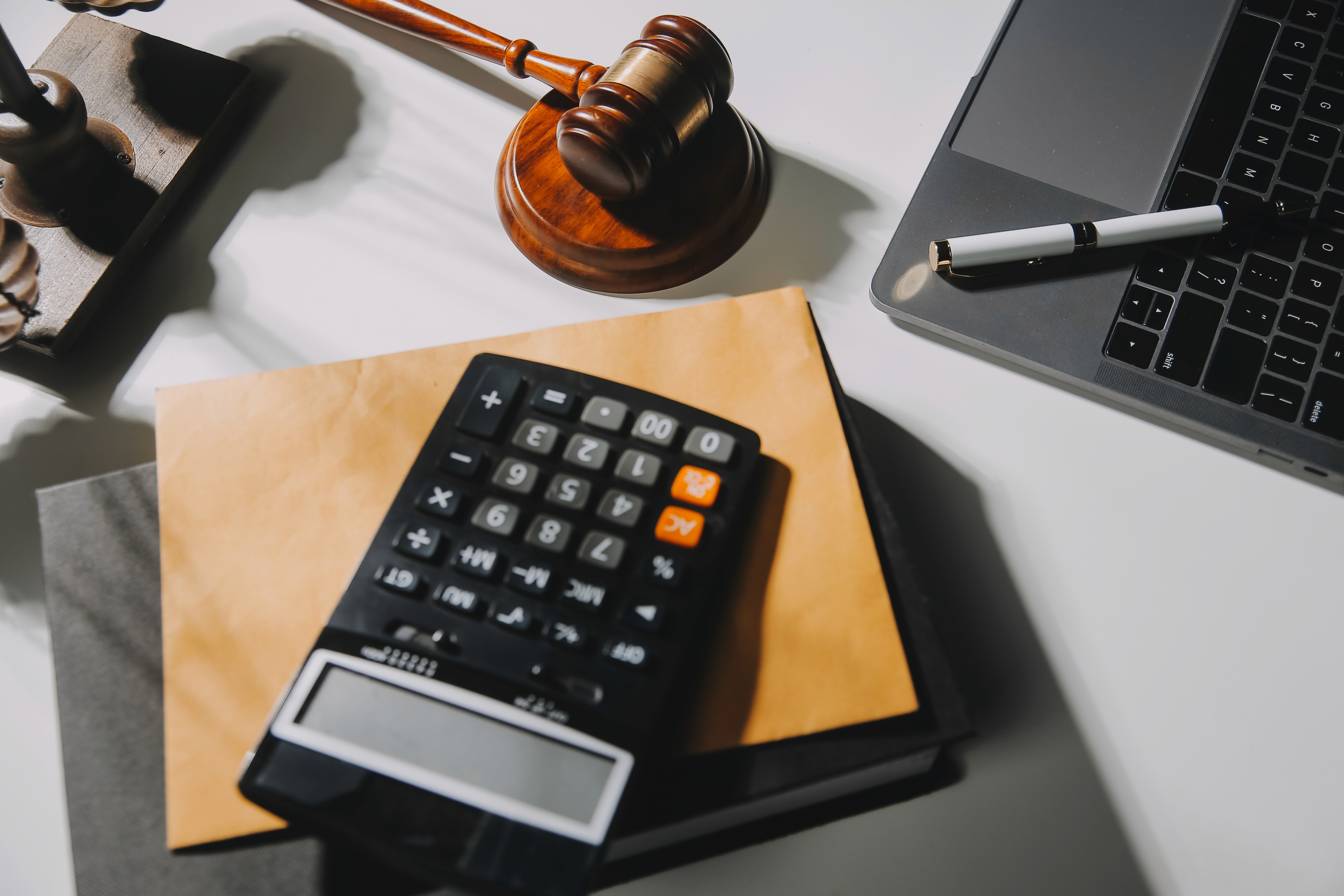 Bachelor of Commerce and Bachelor of Legislative Law (B.Com LL.B) represented by legal gavel, calculator, and laptop symbolizing the combination of business, finance, and law studies