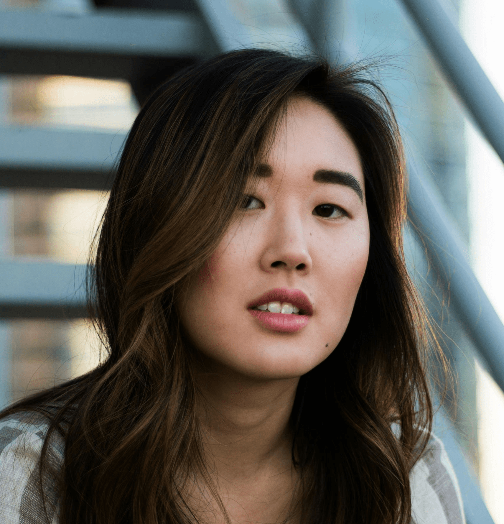 woman sitting on white metal stairs