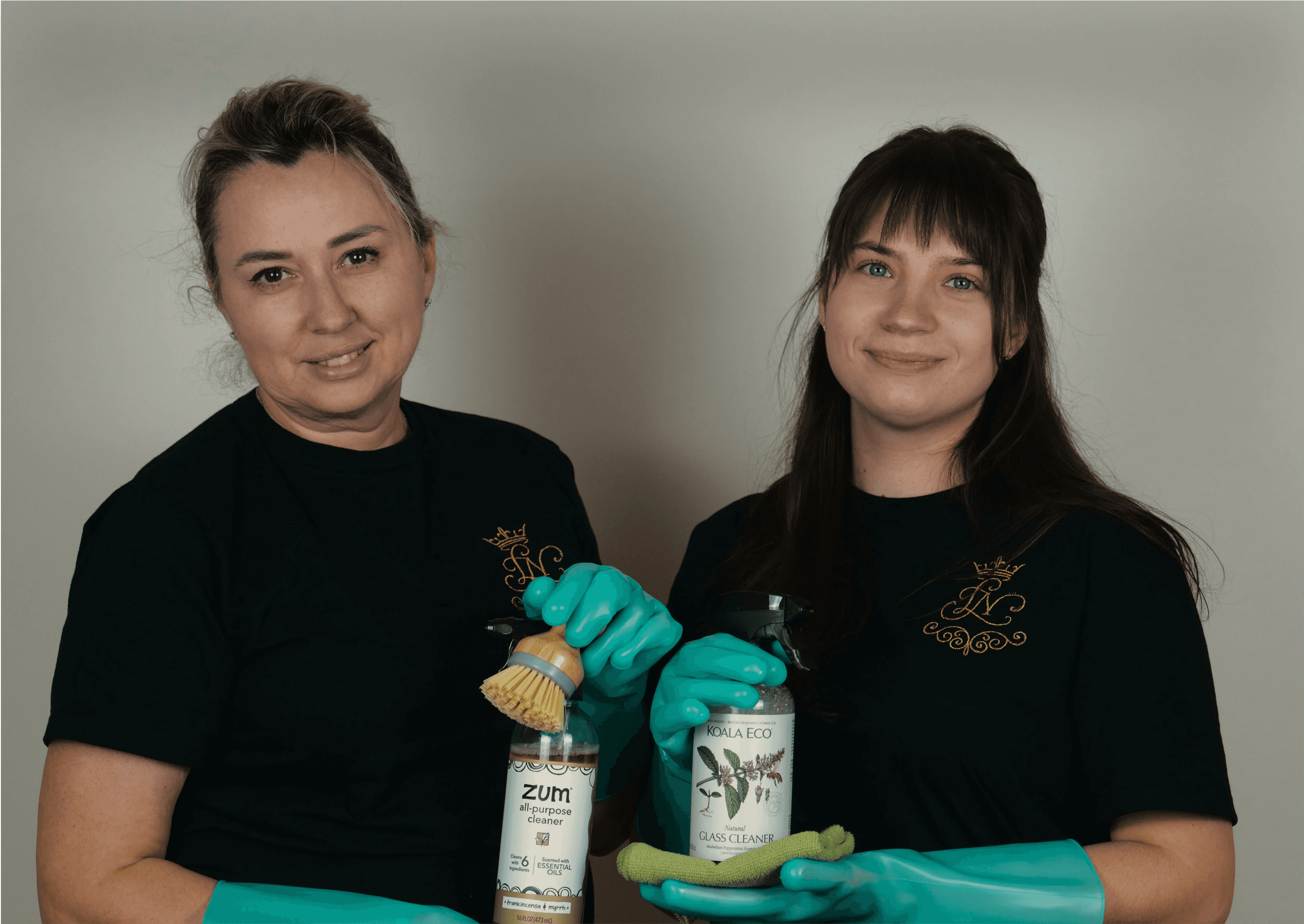 Two young cleaners that hold an eco-product and supplies.