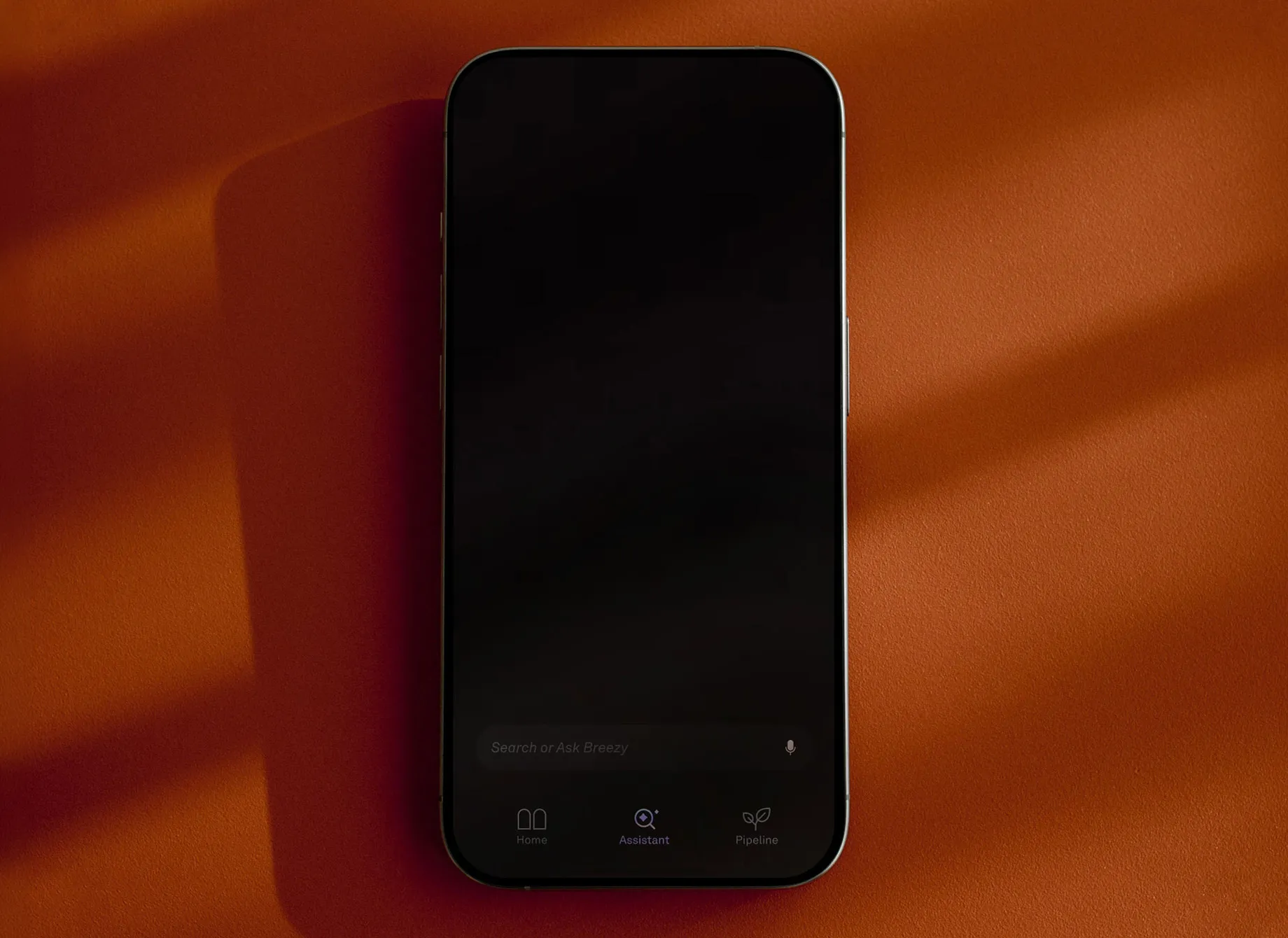 Smartphone displaying the Breezy assistant interface with search and voice input