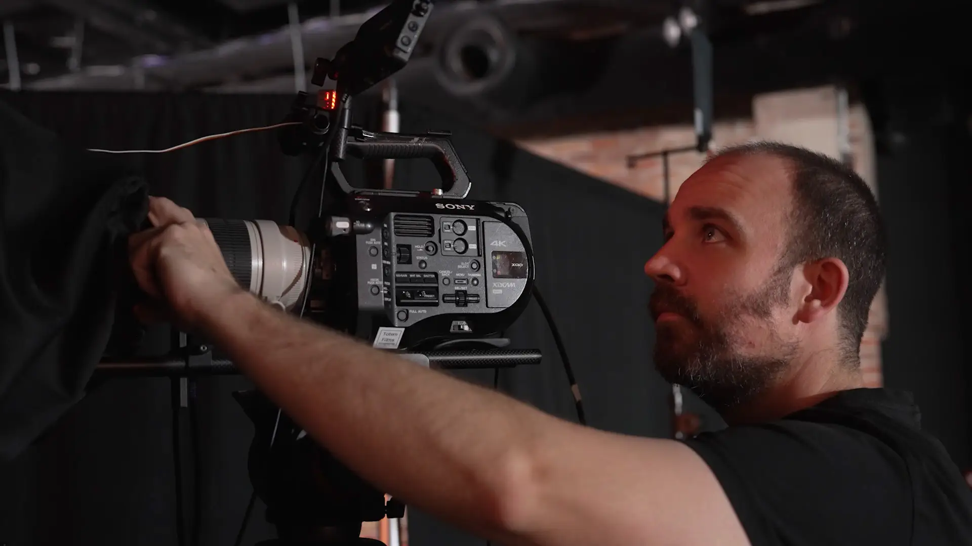 Camera operator adjusting a Sony broadcast camera on set during the Wired x Kyndryl live studio production.