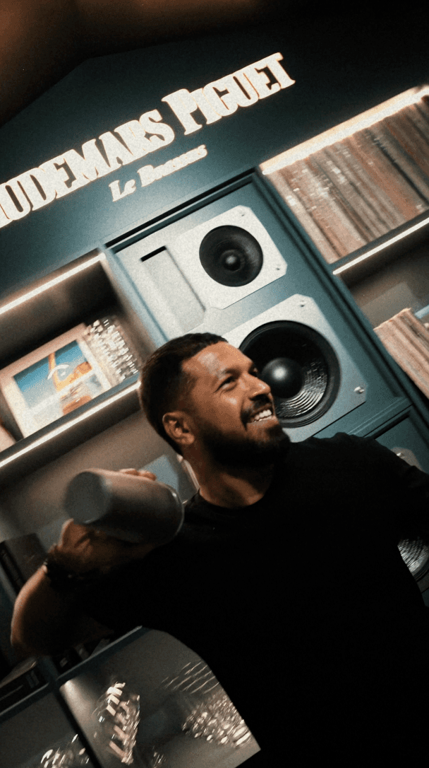 Person's hand petting Shiba Inu dog among fallen leaves