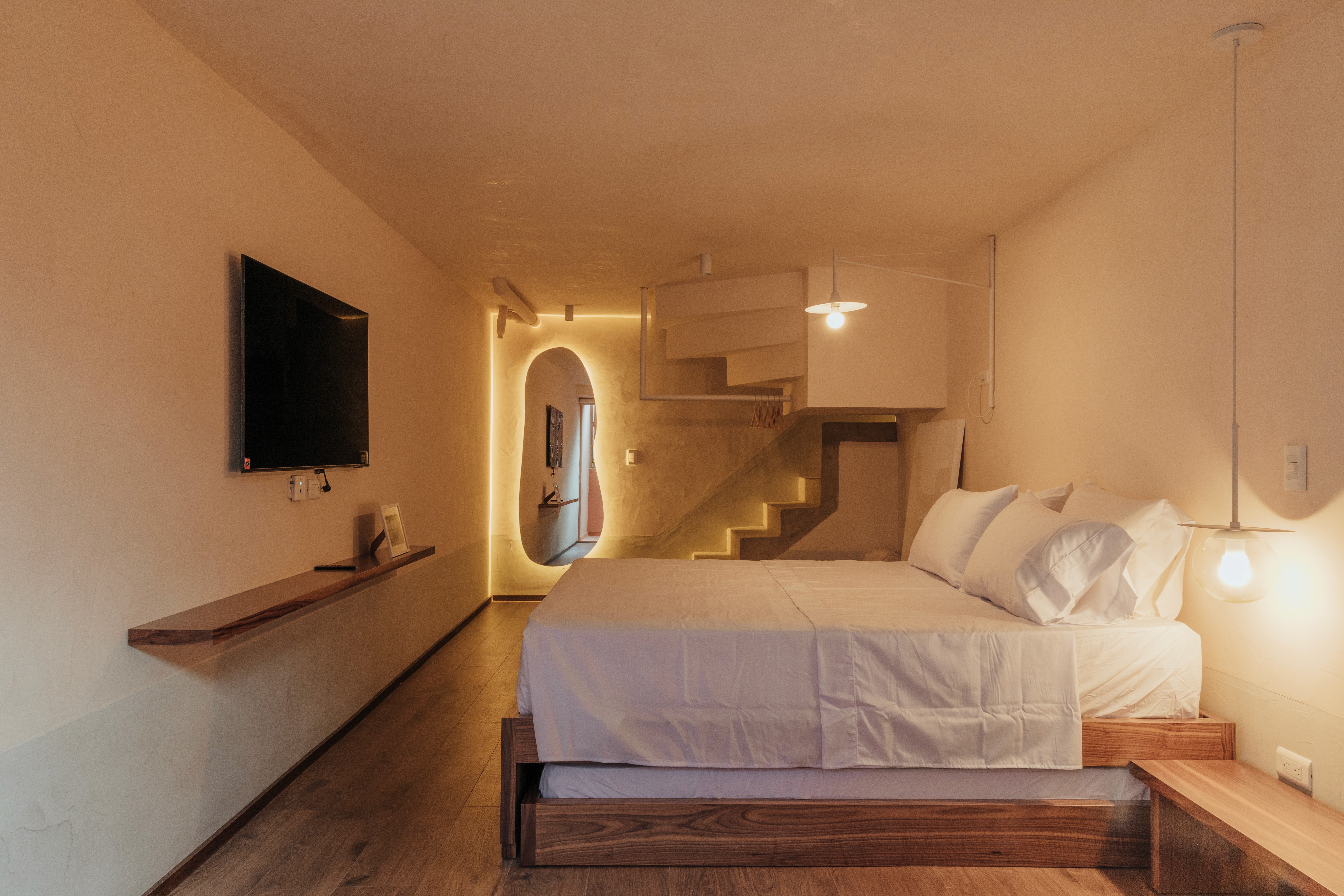Double-height interior with flowing sculptural forms and warm raking light