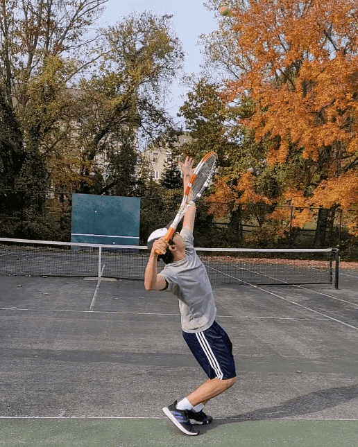Peter playing tennis.