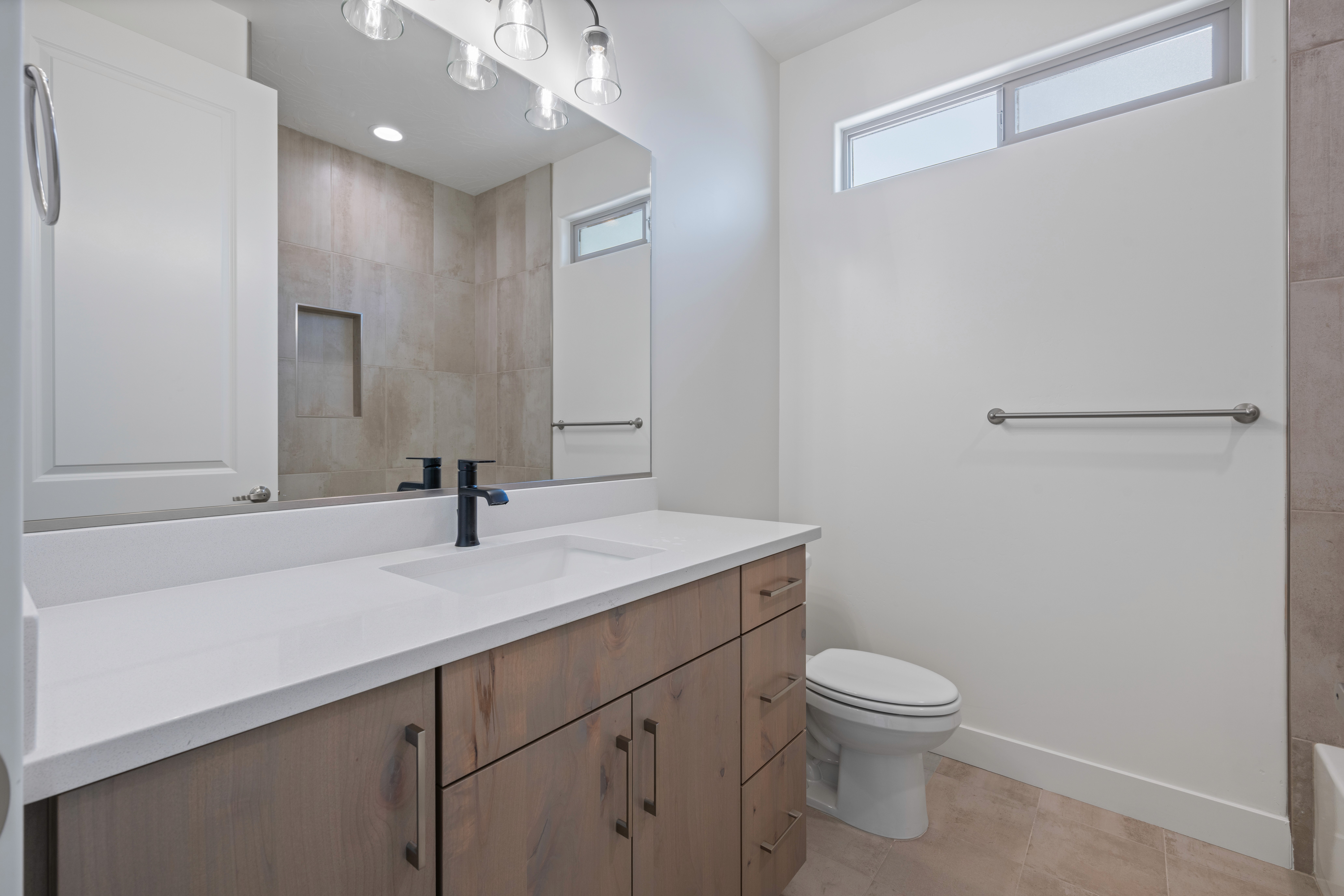 Hall bathroom in The Nest at Falcon Ridge custom home in Hurricane, Utah, with modern vanity and tile details.