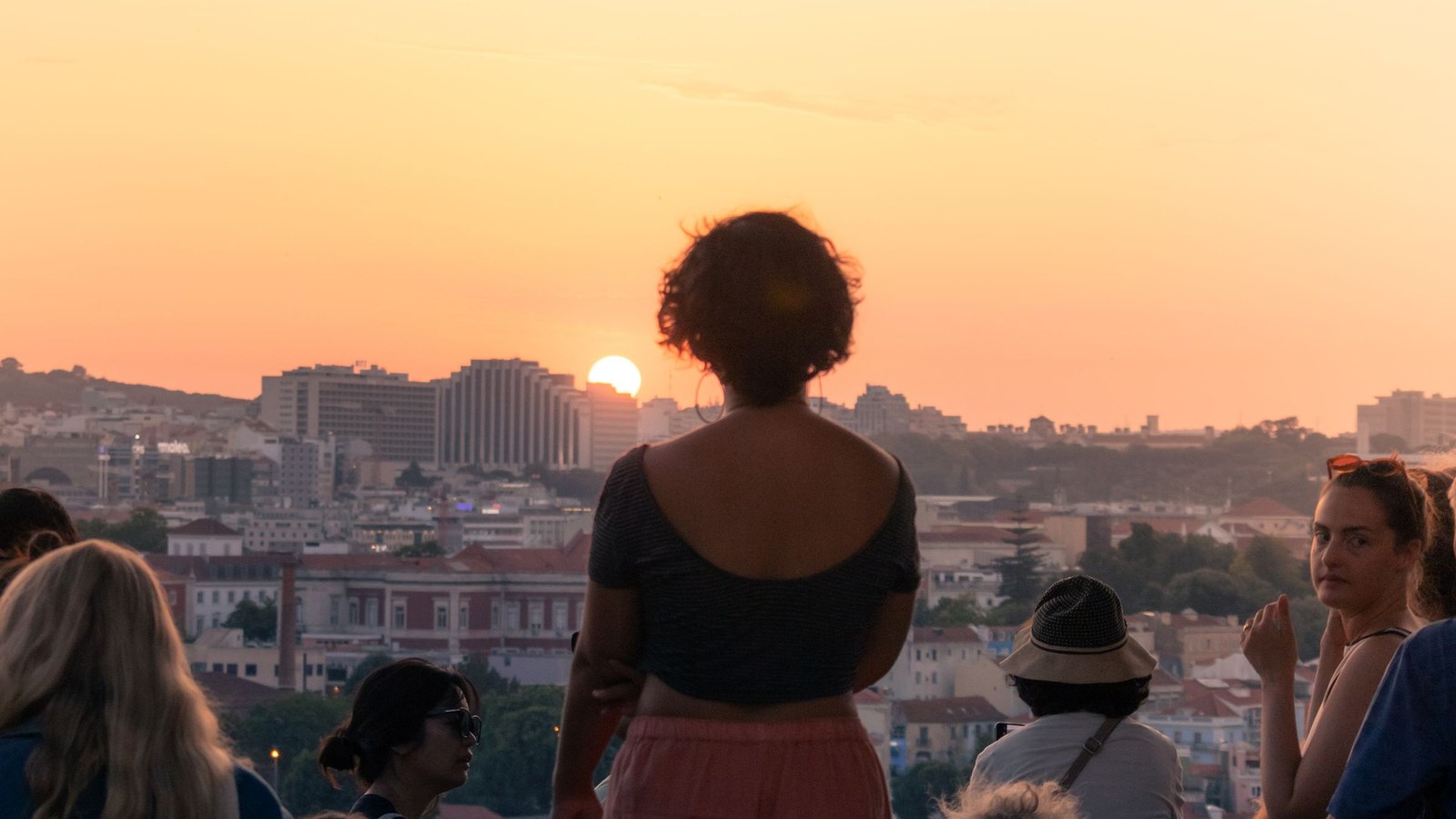 People watching sunset over the Lisbon skyline