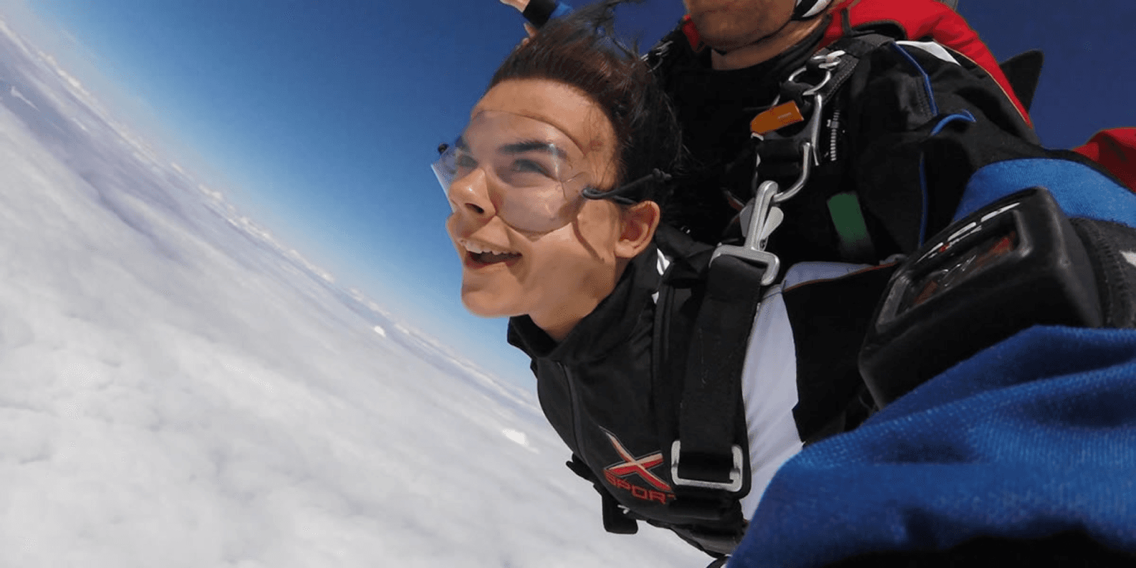 Adventurer enjoying a skydiving experience with Xsport, symbolizing the thrill and safety-focused adventure tourism services offered by the company.