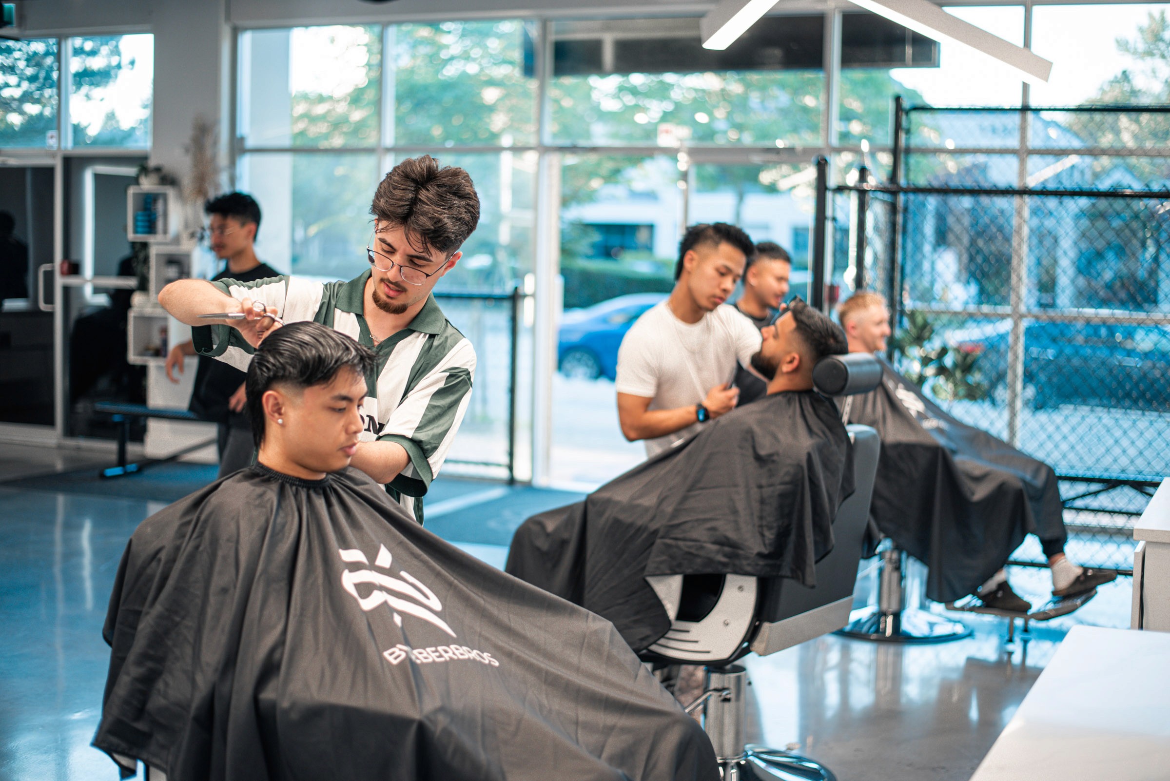 Beige golf cart parked on a green course with a canvas tote bag hanging on the side, decorated with green stripes and a logo.