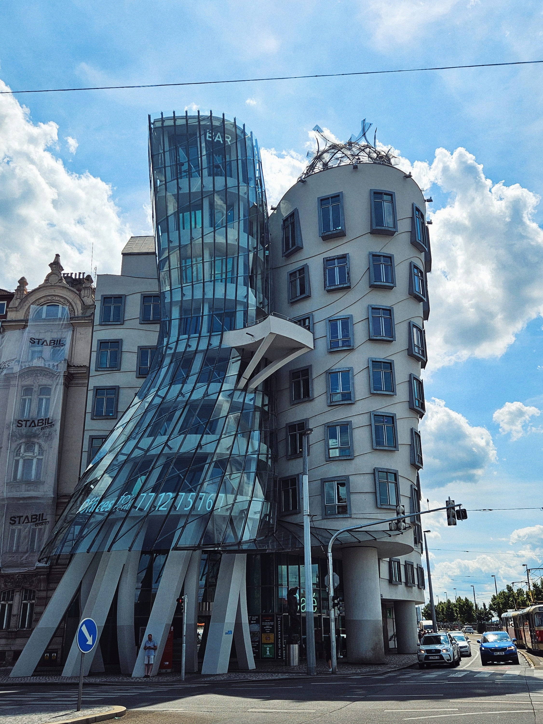 a japanese style building with a japanese roof and trees around it