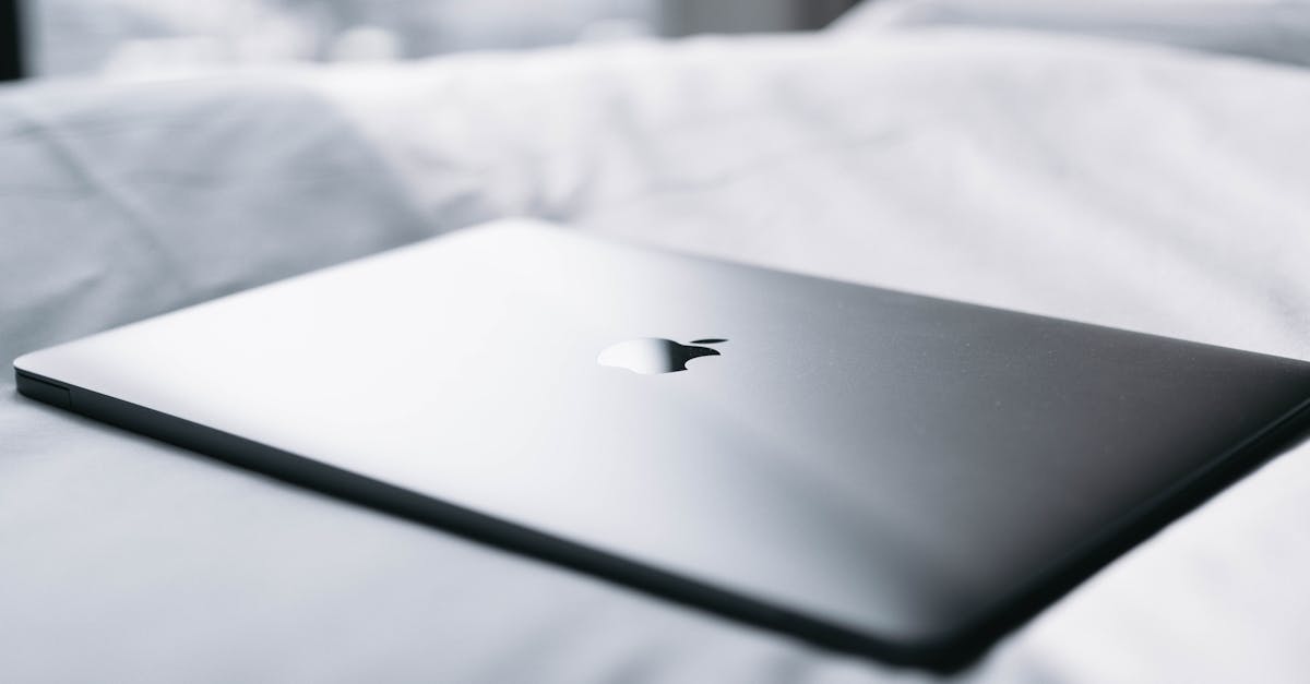 Thin laptop resting on crisp white linens, perfect for minimalistic and modern lifestyle imagery.