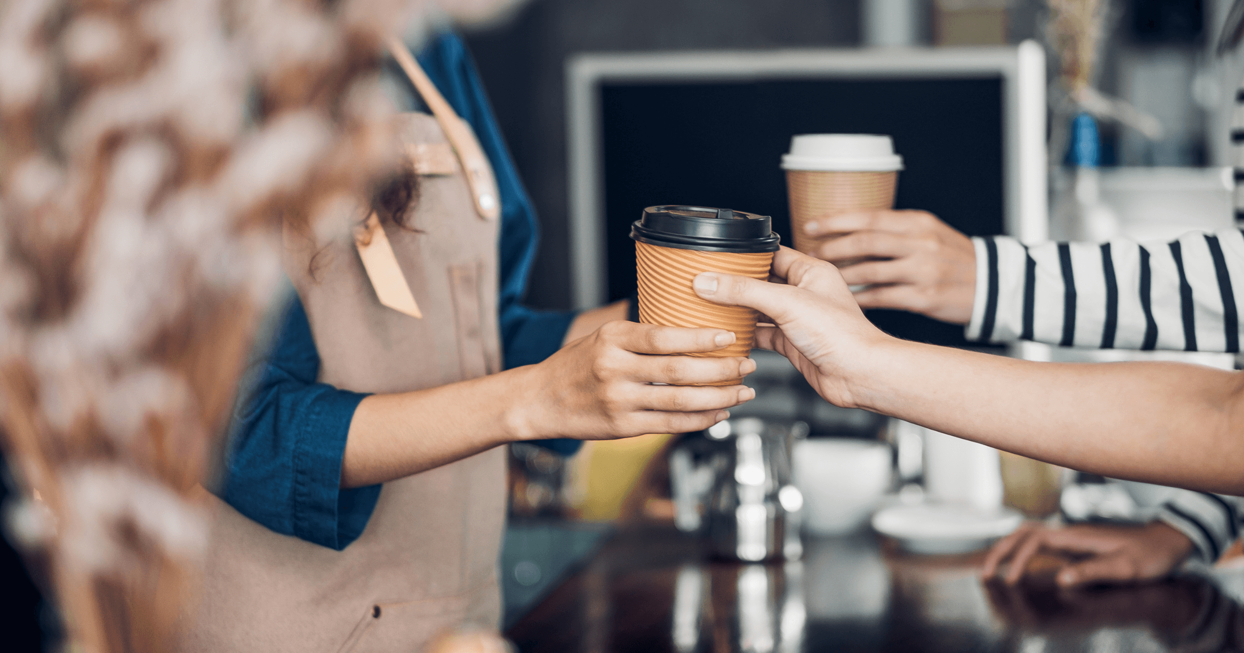 A customer receiving a cup of coffee