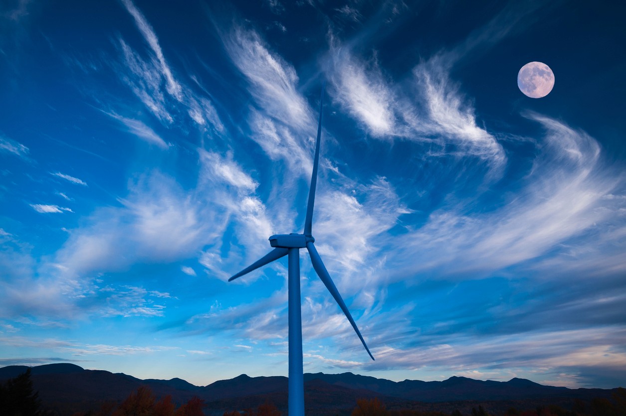 Moonrise over a lone wind turbine in Dexter Minnesota USA