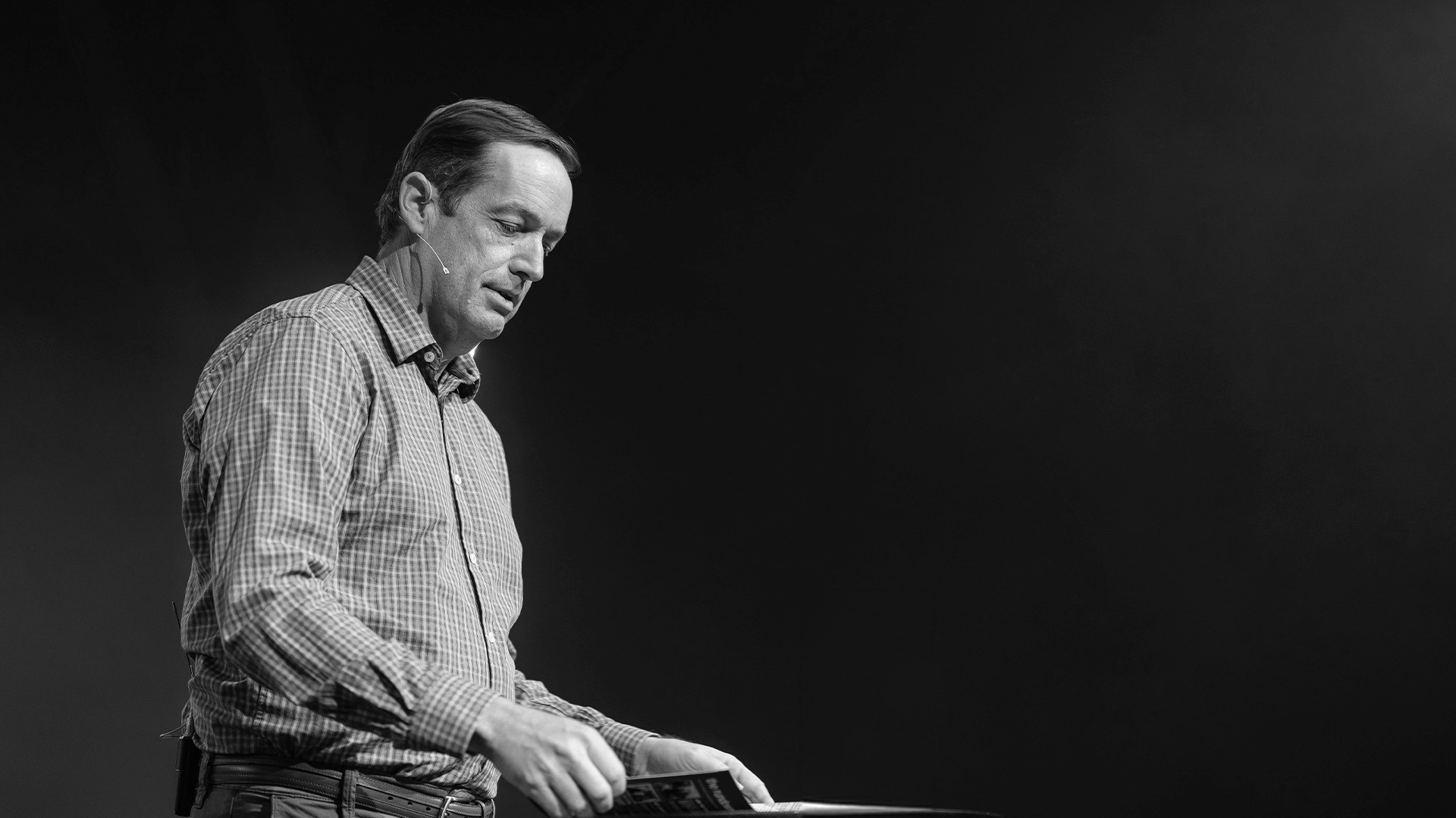 two people looking at a tablet and smiling