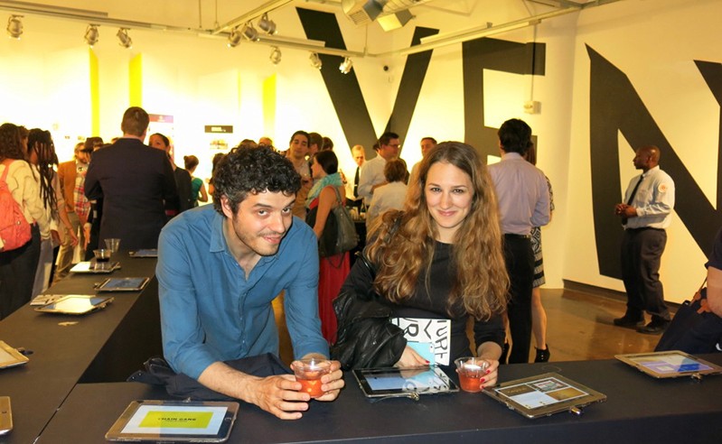 portrait of a man and a woman sitting at a desk