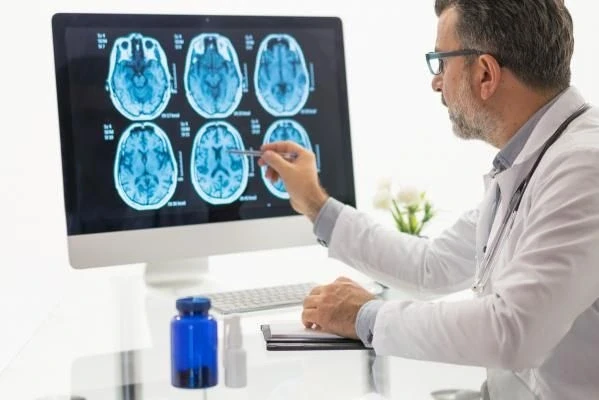 A doctor looking at CT scan of a Patient