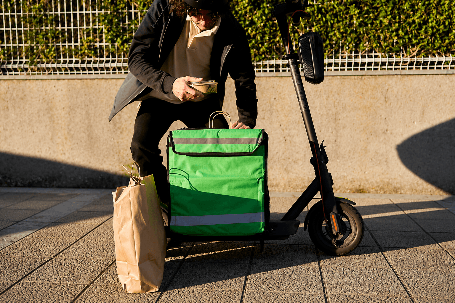 person sitting on grass and using phone