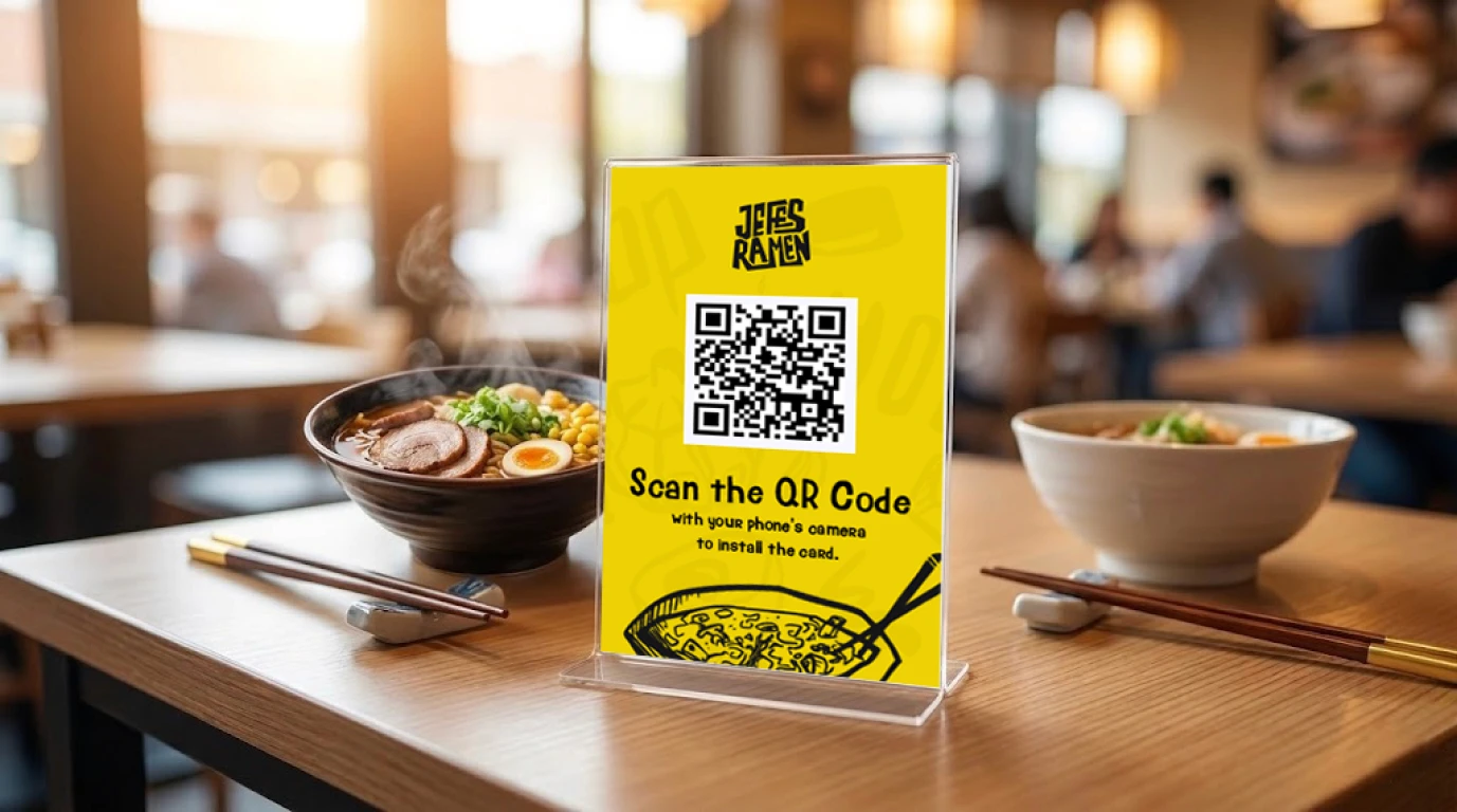 A hot ramen bowl in a table with qr code.
