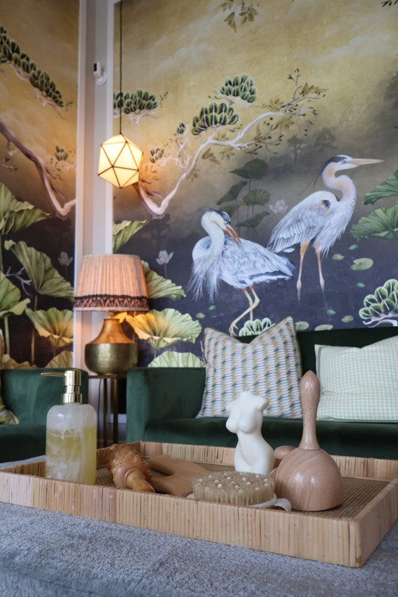 beauty tools organised neatly, mural of birds on wall